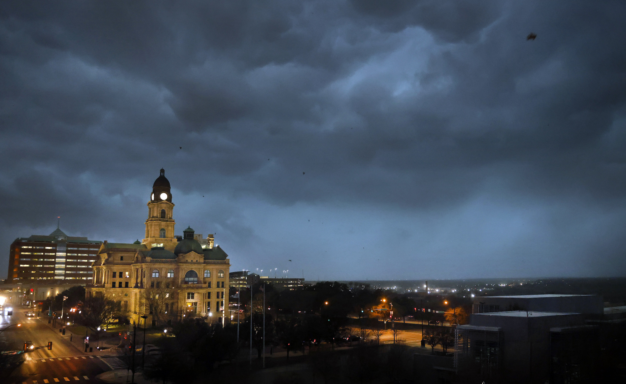 Debris flies through the air as howling winds accompanied by a line of storms approach the old Tarrant County Courthouse in downtown Fort Worth, Texas, on March 2.