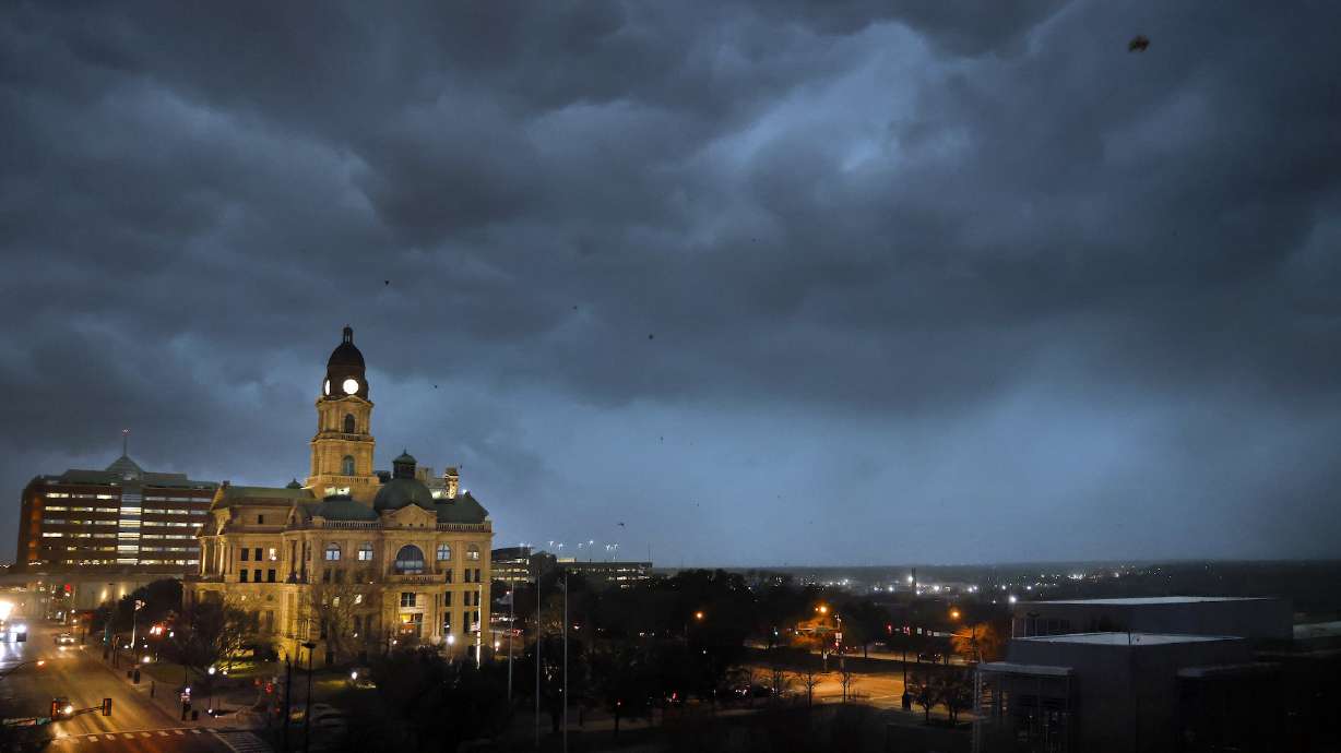 Debris flies through the air as howling winds accompanied by a line of storms approach the old Tarrant County Courthouse in downtown Fort Worth, Texas, on March 2.