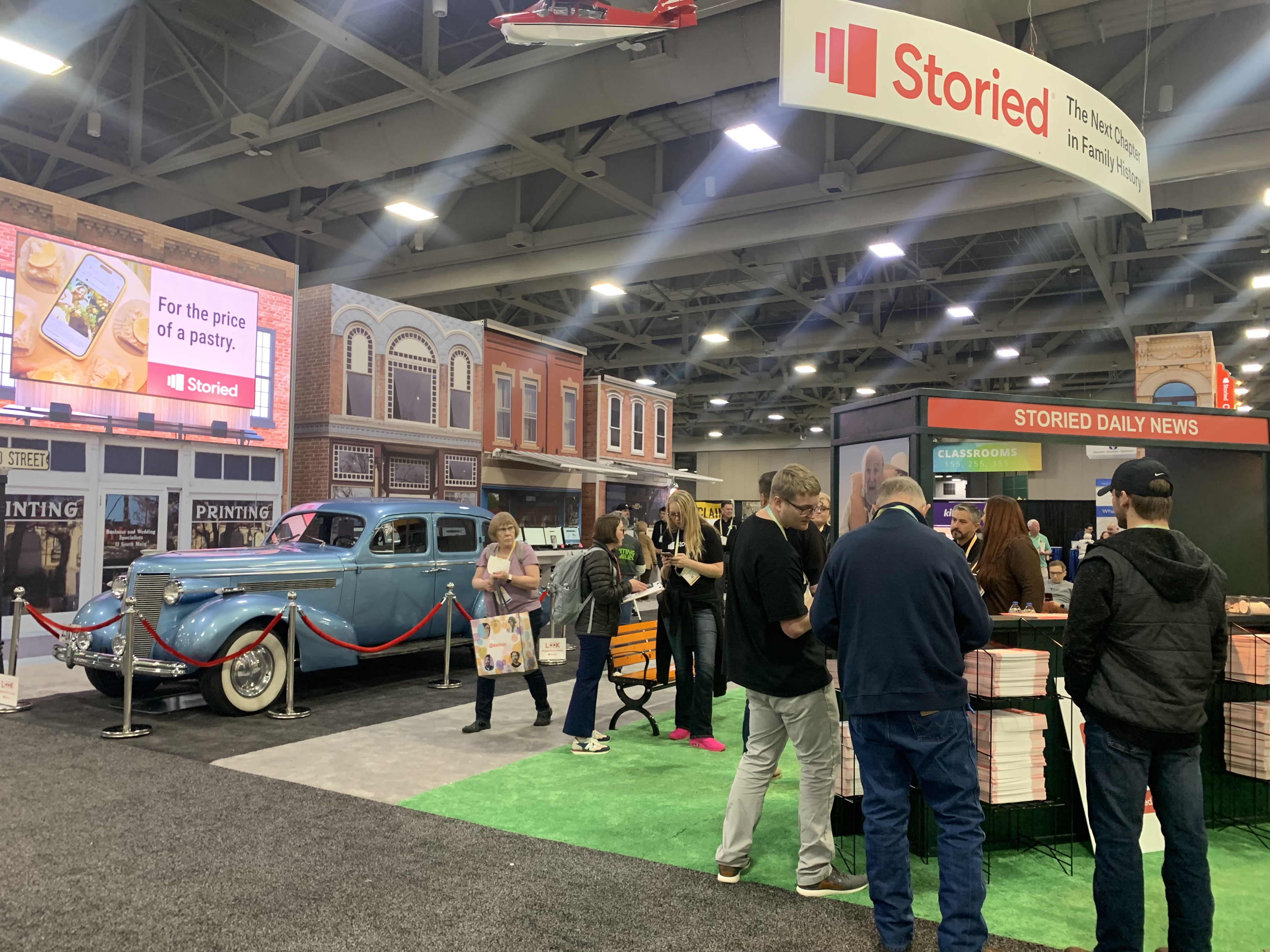People interact at the Storied booth in the Expo Hall at RootsTech on Thursday.
