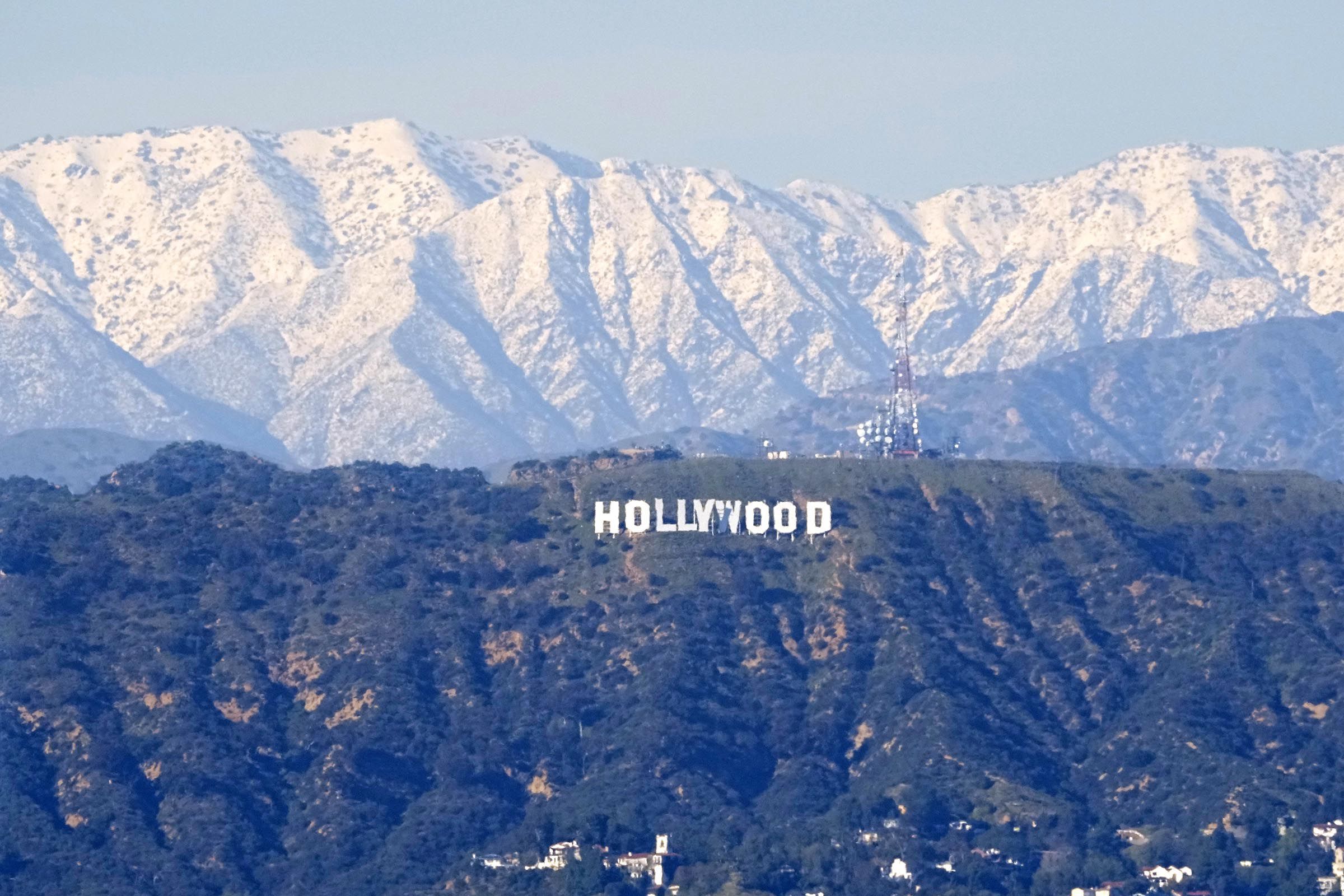 The Hollywood sign is seen with snow-capped mountains behind it from the Baldwin Hills area of Los Angeles Thursday, March 2.