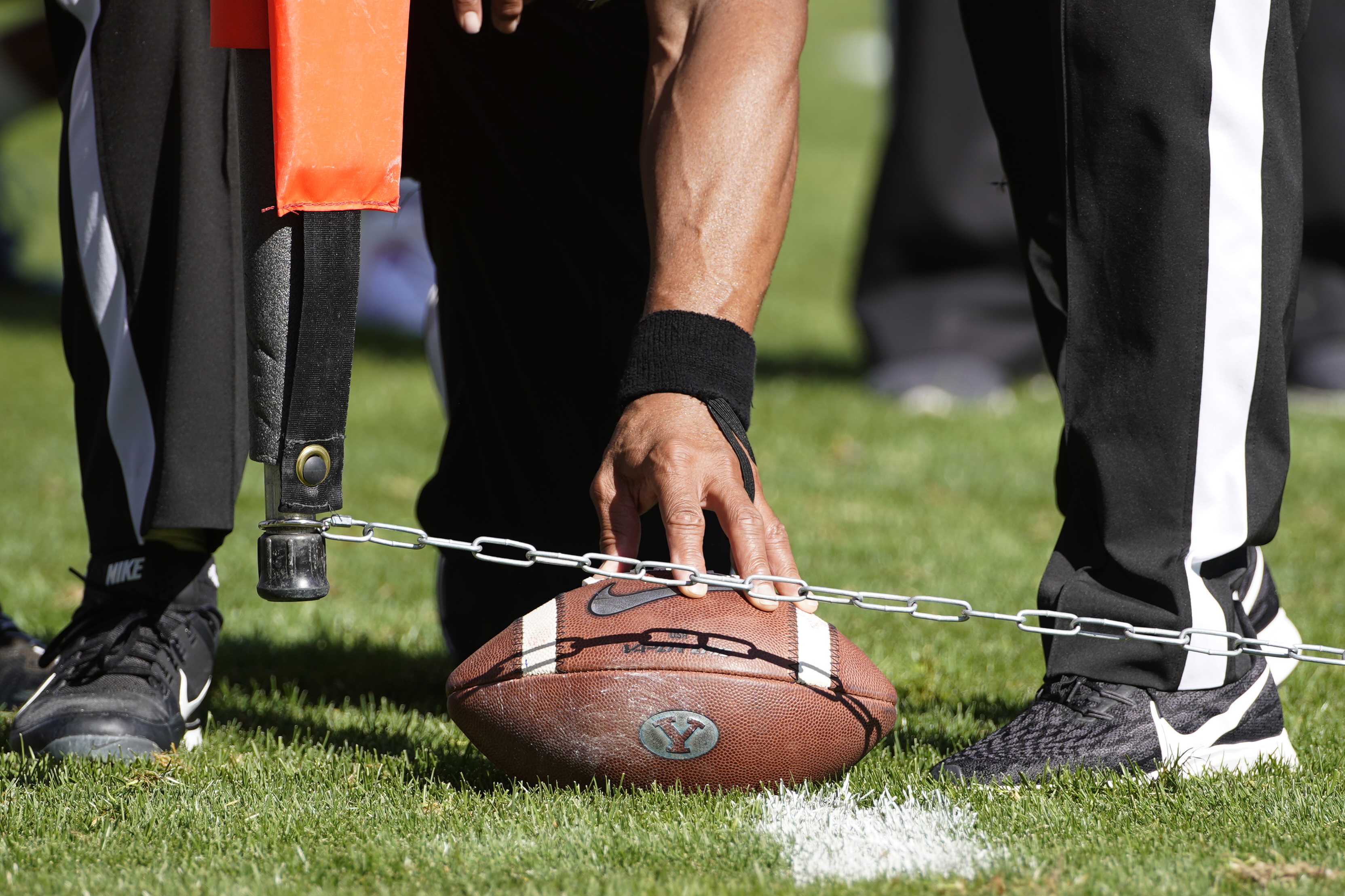FILE - Officials measure for a first down during an NCAA college football game between USC and BYU, Saturday, Sept. 14, 2019, in Provo, Utah. College football administrators are looking at ways to reduce the number of plays in games in the name of player safety, with a tweak in clock operating procedures likely the first step. A proposal to let the game clock continue running when a team makes a first down, except in the last two minutes of a half, has broad support. 