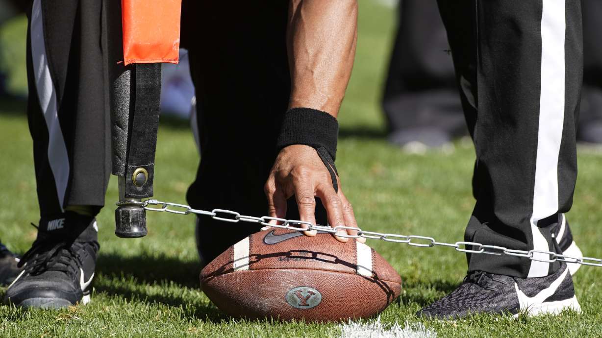FILE - Officials measure for a first down during an NCAA college football game between USC and BYU, Saturday, Sept. 14, 2019, in Provo, Utah. College football administrators are looking at ways to reduce the number of plays in games in the name of player safety, with a tweak in clock operating procedures likely the first step. A proposal to let the game clock continue running when a team makes a first down, except in the last two minutes of a half, has broad support.
