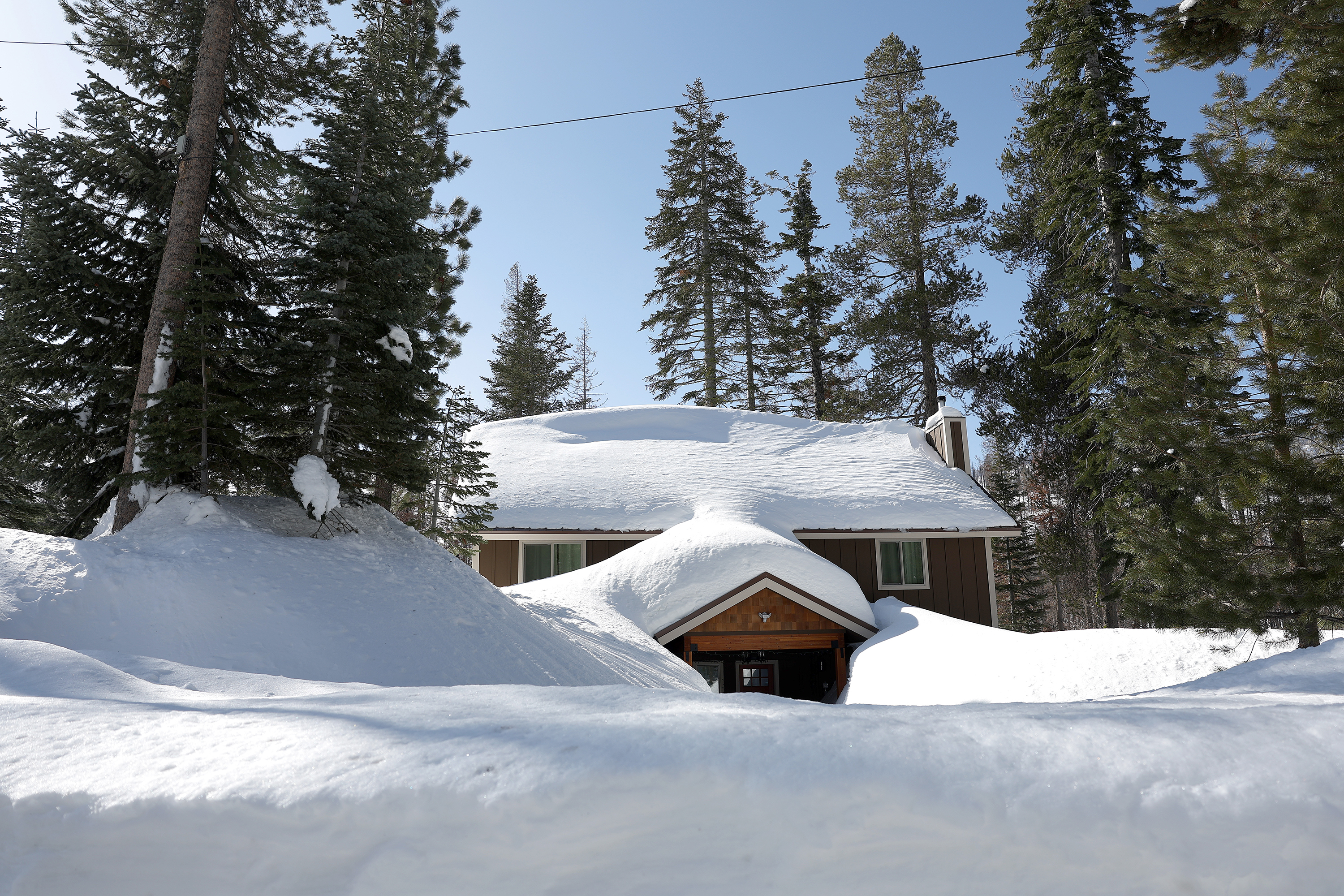 A home is seen buried in snow on Friday in Twin Bridges, California.