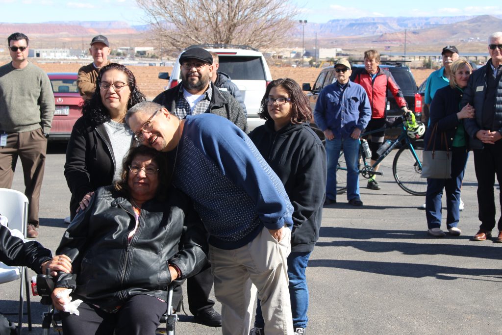 Linda Trujillo, seated left, is surrounded by her family at the newly expanded Utah Food Bank Southern Distribution Center, St. George, Utah, Thursday.