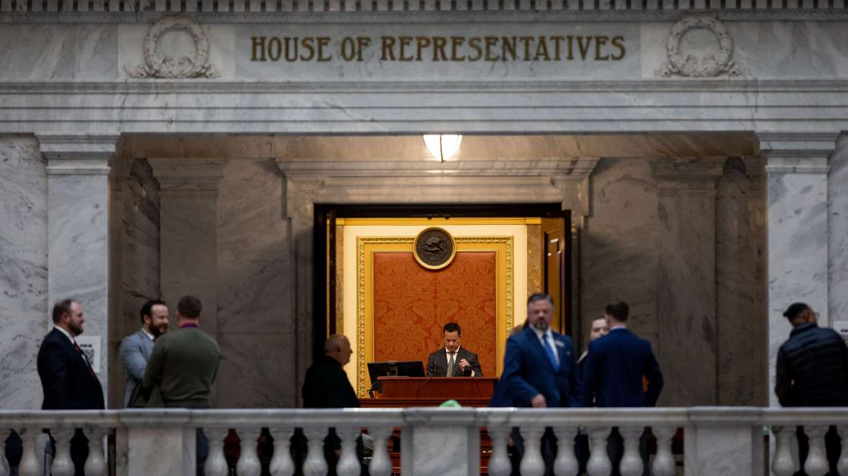 House Speaker Brad Wilson, R-Kaysville, is seen at the lectern through the open doors of the House Chamber at the Capitol in Salt Lake City on the last night of the legislative session, Friday. The session came to an end after legislators hashed out essentially all of the headlining issues and finalized the state's record $29 billion budget.
