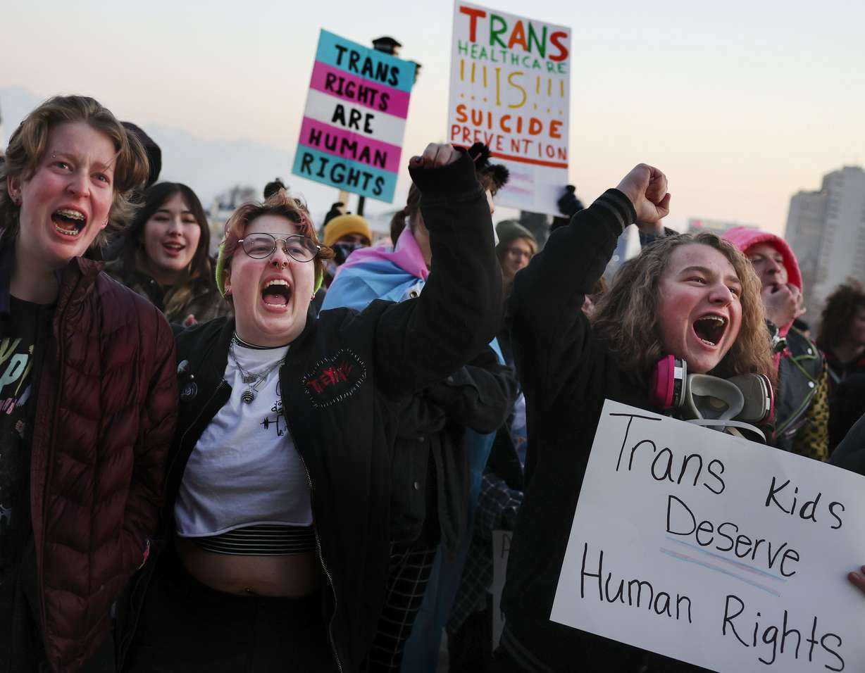 Elliot Ellis, left, Eamon Christiansen and Aiden Muhlestein rally in support of transgender youth at the Capitol in Salt Lake City on Feb. 1.