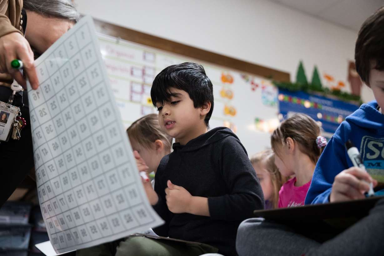 Taim Ahmed looks for a number during a math lesson during a full-day kindergarten class at East Sandy Elementary School in Sandy on Feb. 27.