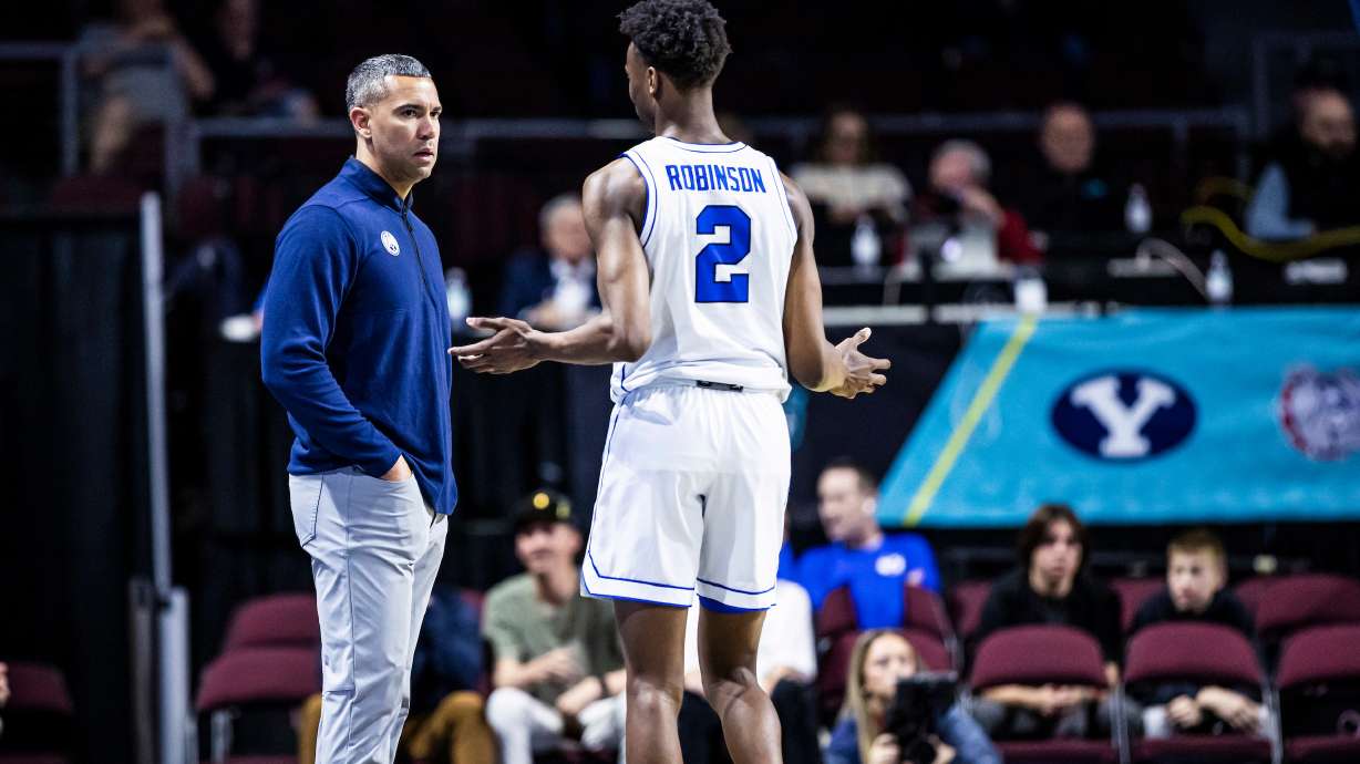 BYU wing Jaxson Robinson with assistant coach Kahil Fennell against Portland in the West Coast Conference Tournament, Friday, March 3, 2023 at Orleans Arena in Las Vegas.