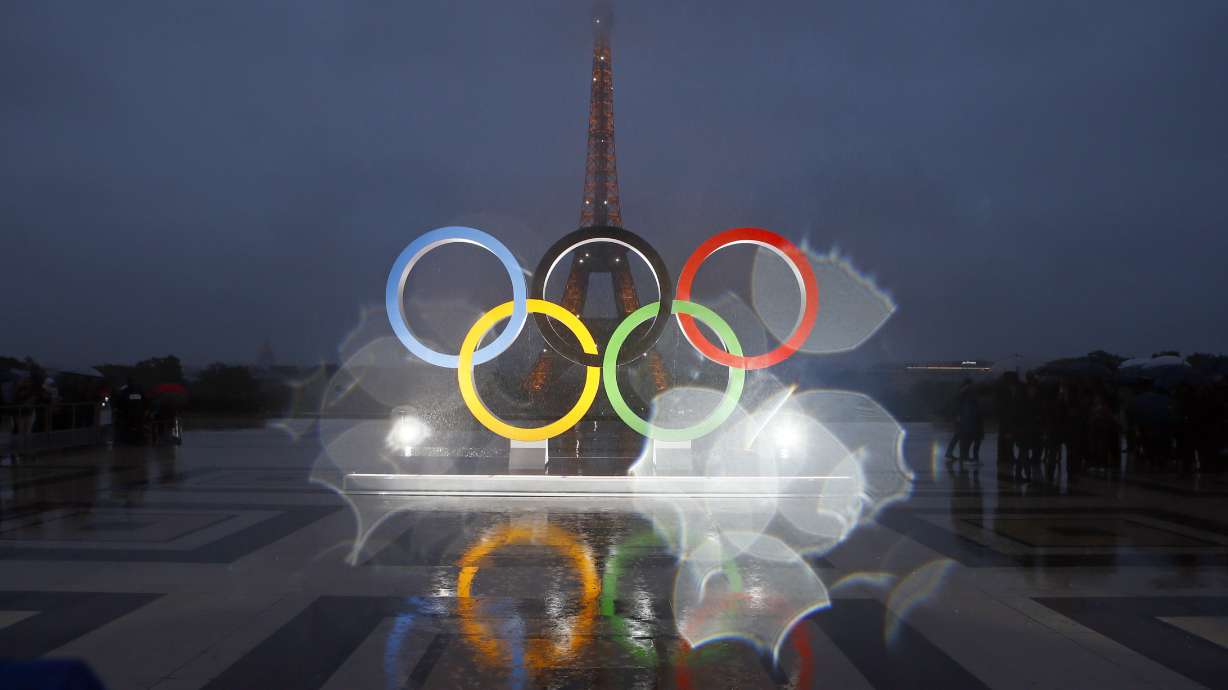 FILE - The Olympic rings are seen on the Place du Trocadero that overlooks the Eiffel Tower, after the vote in Lima, Peru, awarding the 2024 Games to the French capital, in Paris, Sept. 13, 2017. Organizers of the Paris 2024 Olympics promised Games with a relatively modest price tag and "egalitarian" access to events, thanks to an online draw meant to revolutionize ticket sales and bring the masses to next year's Olympics with prices as low as 24 euros ($26). But as the first round of ticketing winds down, many "lucky" winners chosen for the draw are feeling frustrated, angry and cheated, as their only option during the 48-hour purchasing window was paying at least 200 euros per ticket for the few remaining events on offer.