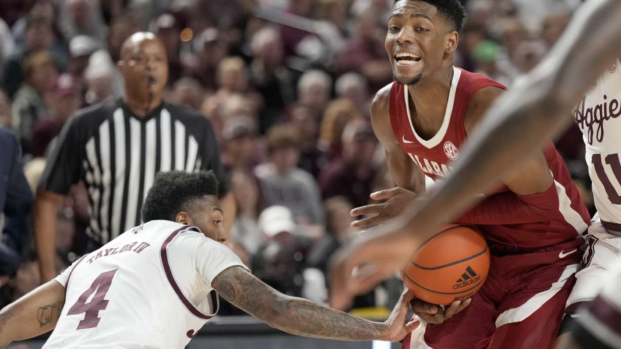 Alabama forward Brandon Miller (24) has the ball knocked away from him by Texas A&M guard Wade Taylor IV (4) while driving the lane during the first half of an NCAA college basketball game Saturday, March 4, 2023, in College Station, Texas.