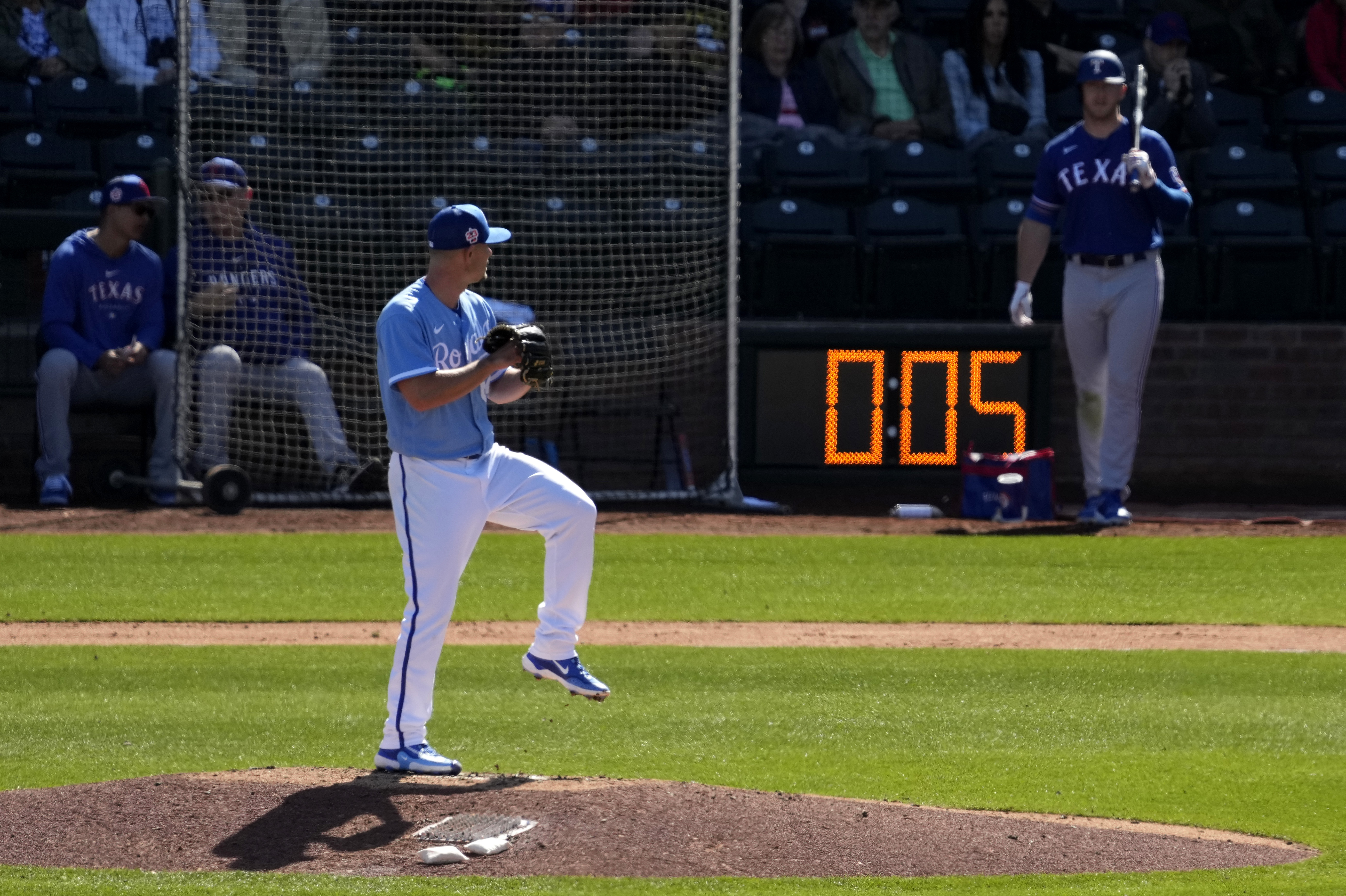 Kansas City Royals Nick Wittgren throws before a pitch clock runs down during the fifth inning of a spring training baseball game against the Texas Rangers Friday, Feb. 24, 2024, in Surprise, Ariz. 