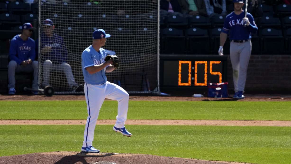Kansas City Royals Nick Wittgren throws before a pitch clock runs down during the fifth inning of a spring training baseball game against the Texas Rangers Friday, Feb. 24, 2024, in Surprise, Ariz.