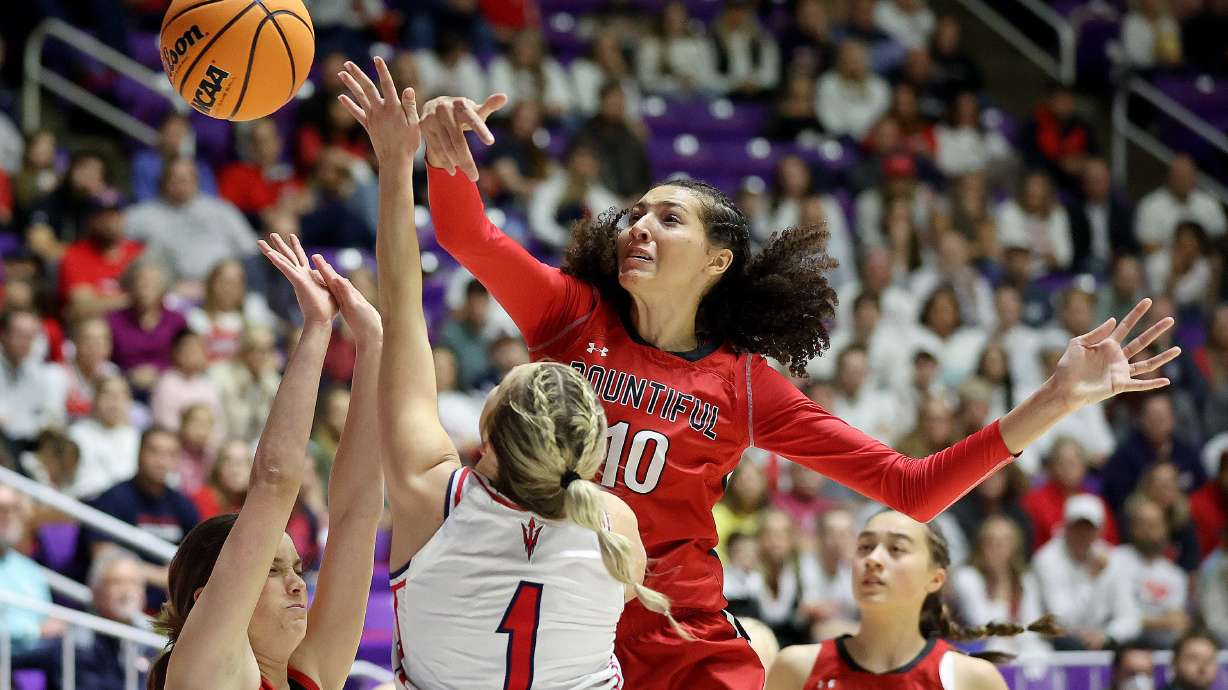 Bountiful’s Taylor Harvey blocks a shot by Springville’s Ellie Esplin as Bountiful’s Hayley Smith guards Esplin during the 5A girls basketball championship game at the Dee Events Center in Ogden, on Saturday, March 4, 2023. Bountiful won 41-39.