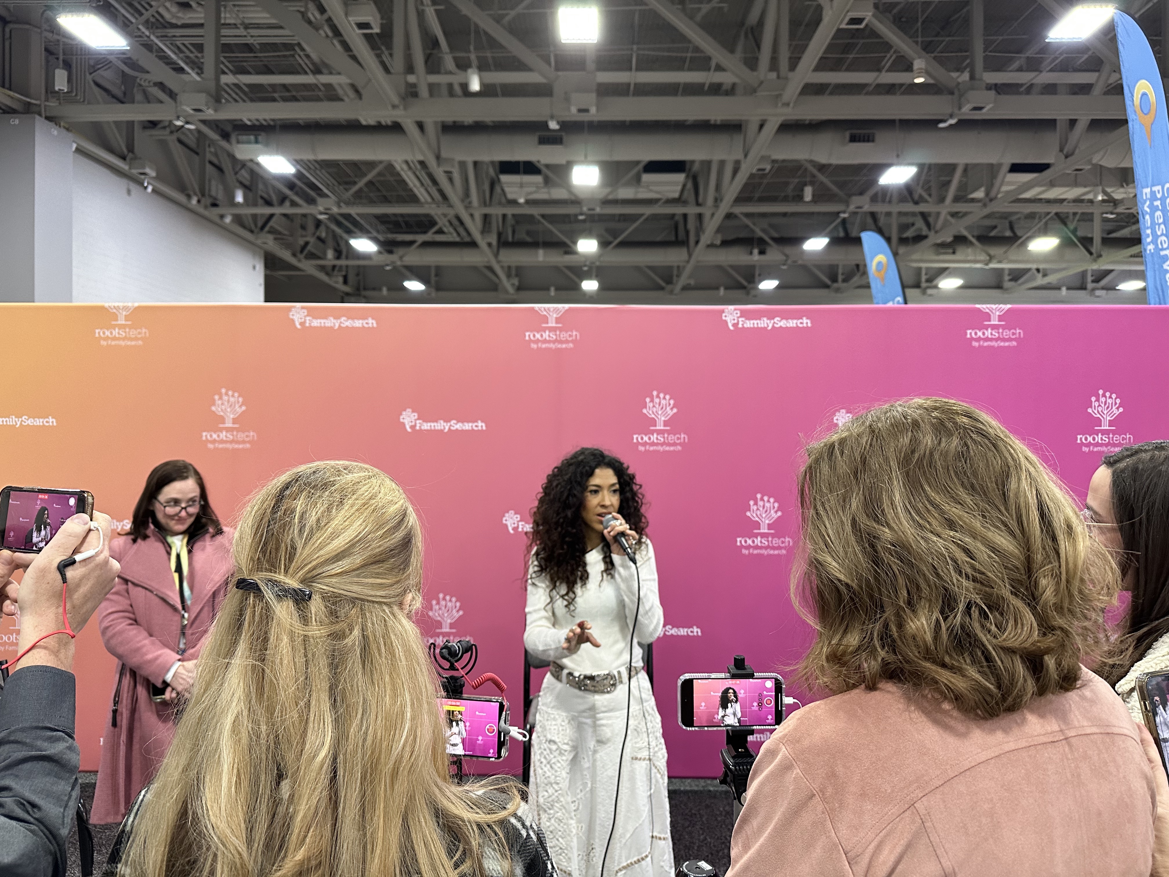 Voice actress and singer Adassa speaks to reporters after her performance at RootsTech in Salt Lake City on Saturday.
