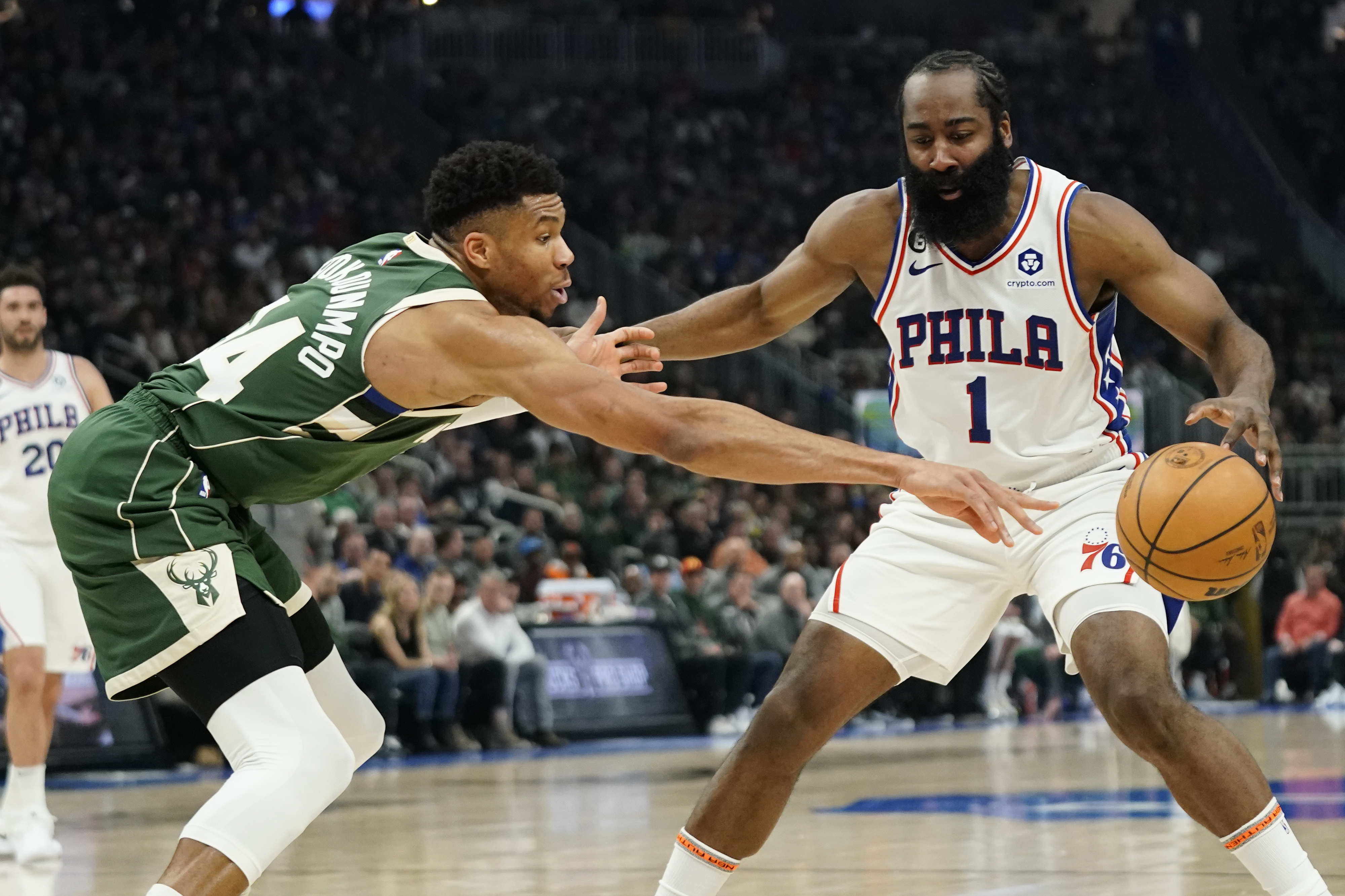 Philadelphia 76ers' James Harden (1) controls the ball against Milwaukee Bucks' Giannis Antetokounmpo during the first half of an NBA basketball game Saturday, March 4, 2023, in Milwaukee.