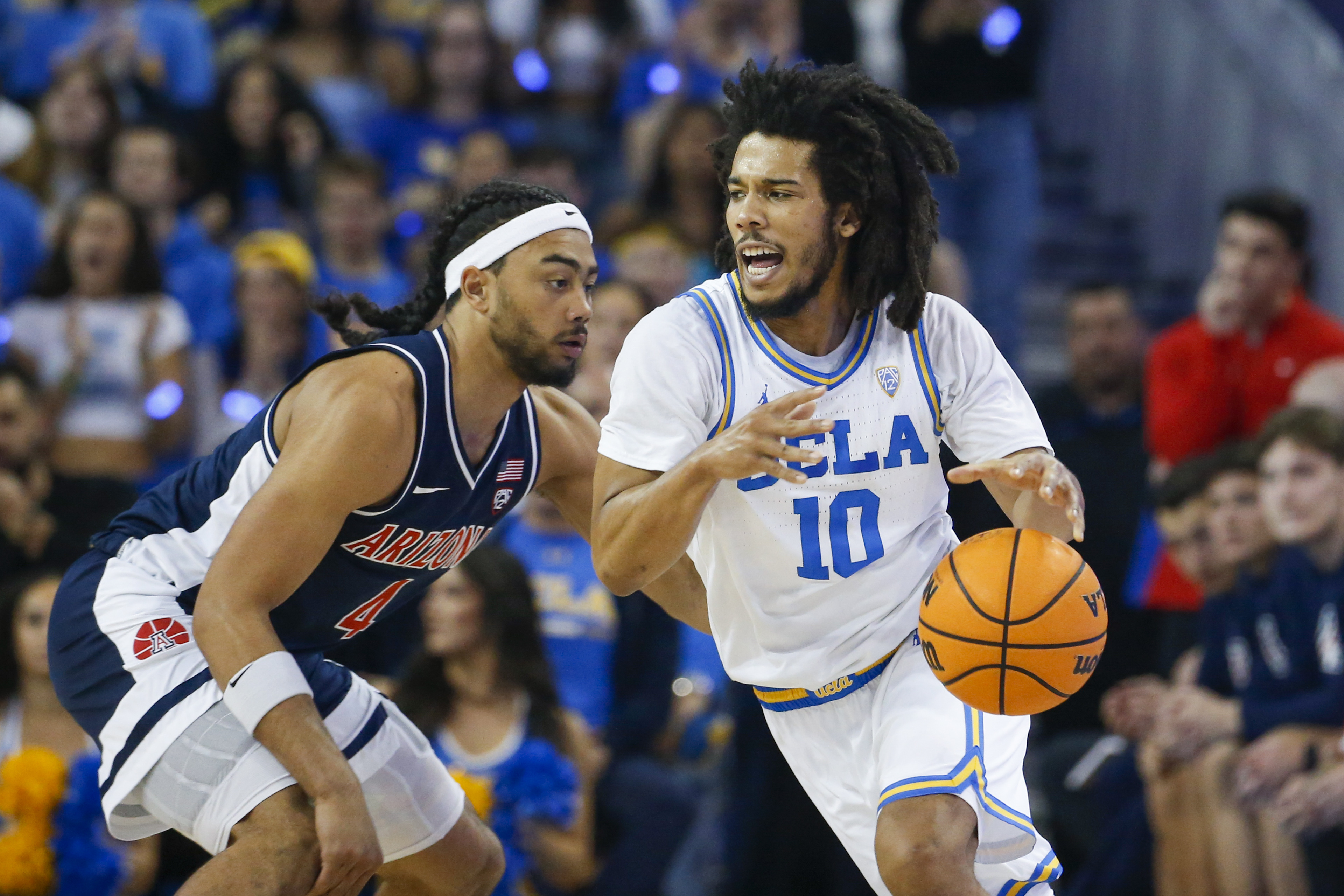 UCLA guard Tyger Campbell, right, drives past Arizona guard Kylan Boswell during the first half of an NCAA college basketball game Saturday, March 4, 2023, in Los Angeles. 