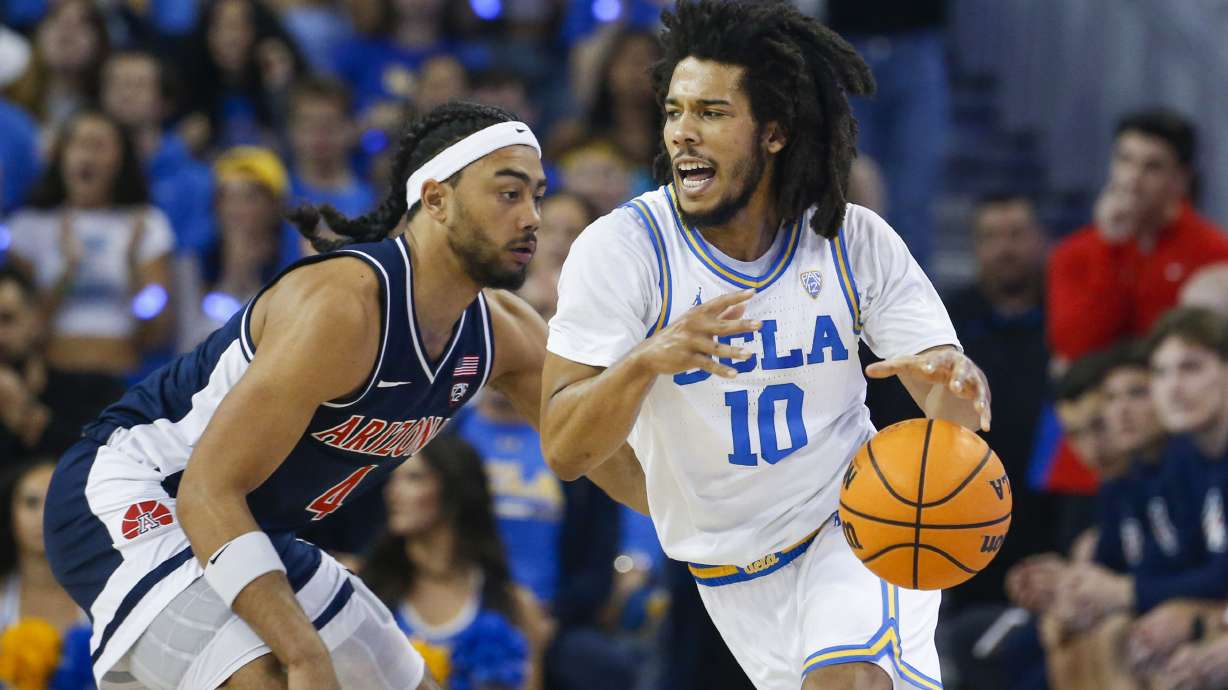 UCLA guard Tyger Campbell, right, drives past Arizona guard Kylan Boswell during the first half of an NCAA college basketball game Saturday, March 4, 2023, in Los Angeles.