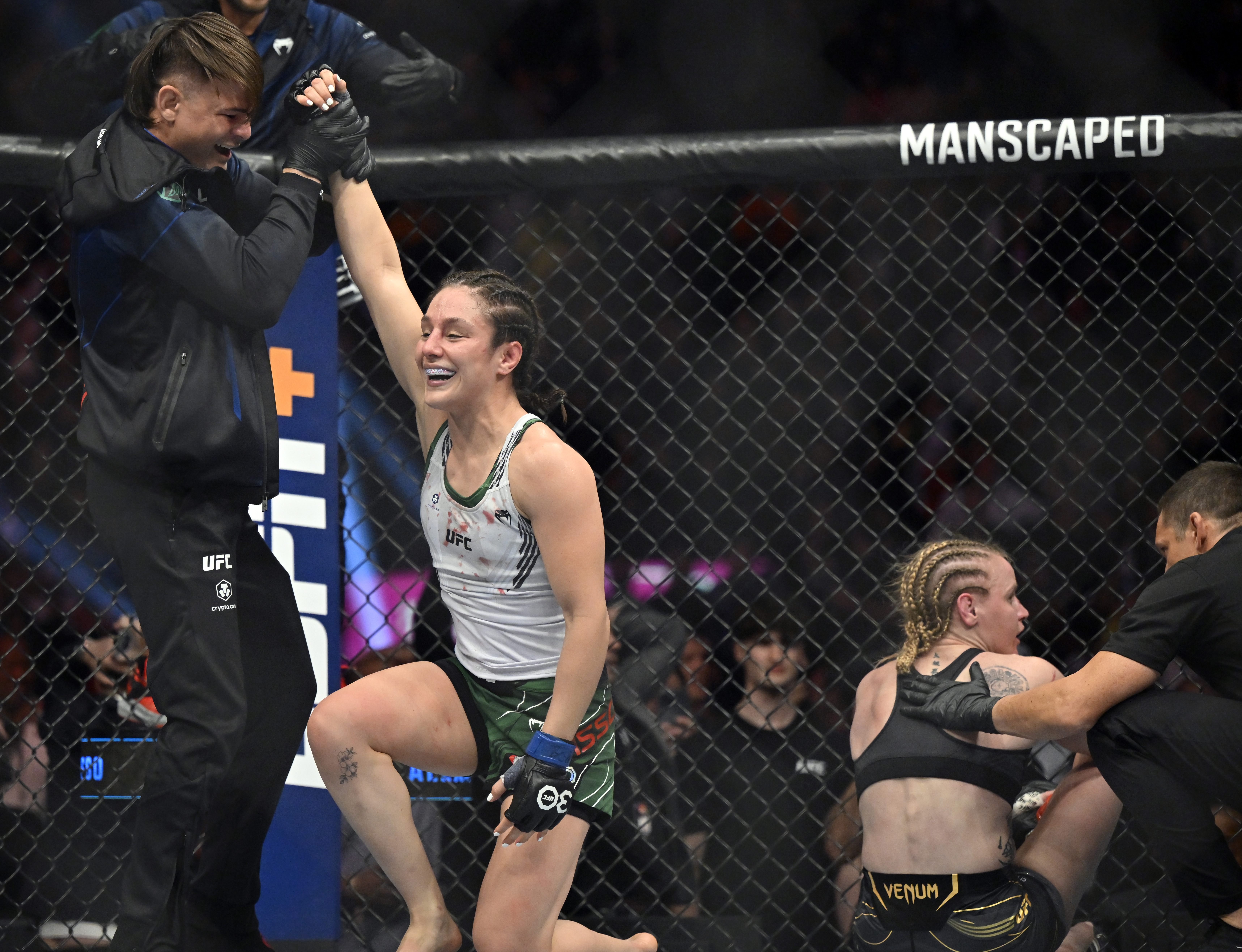 Alexa Grasso, left, is helped up after defeating Valentina Shevchenko in a UFC 285 mixed martial arts flyweight title bout Saturday, March 4, 2023, in Las Vegas.