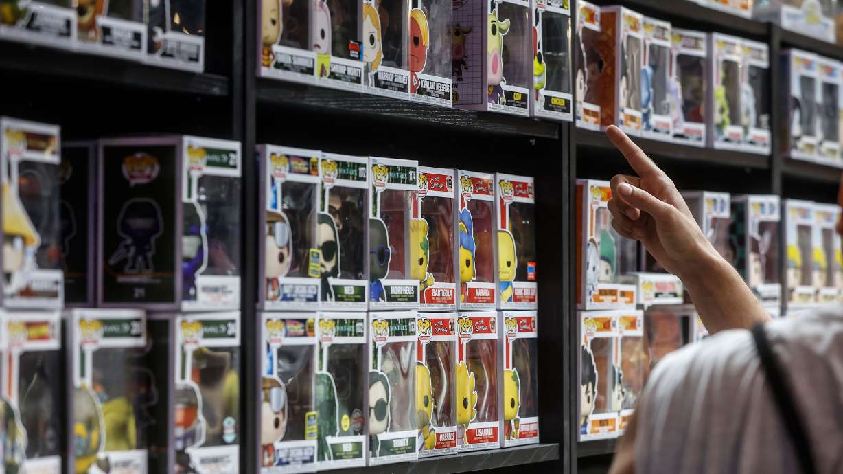 A man points to a shelf of 'Funko Pop' at the 10th edition of DreamHack, at the Forum center Feria Valencia, on July 1, 2022, in Valencia, Comunidad Valenciana, Spain. The toy collector items are no longer holding their value.