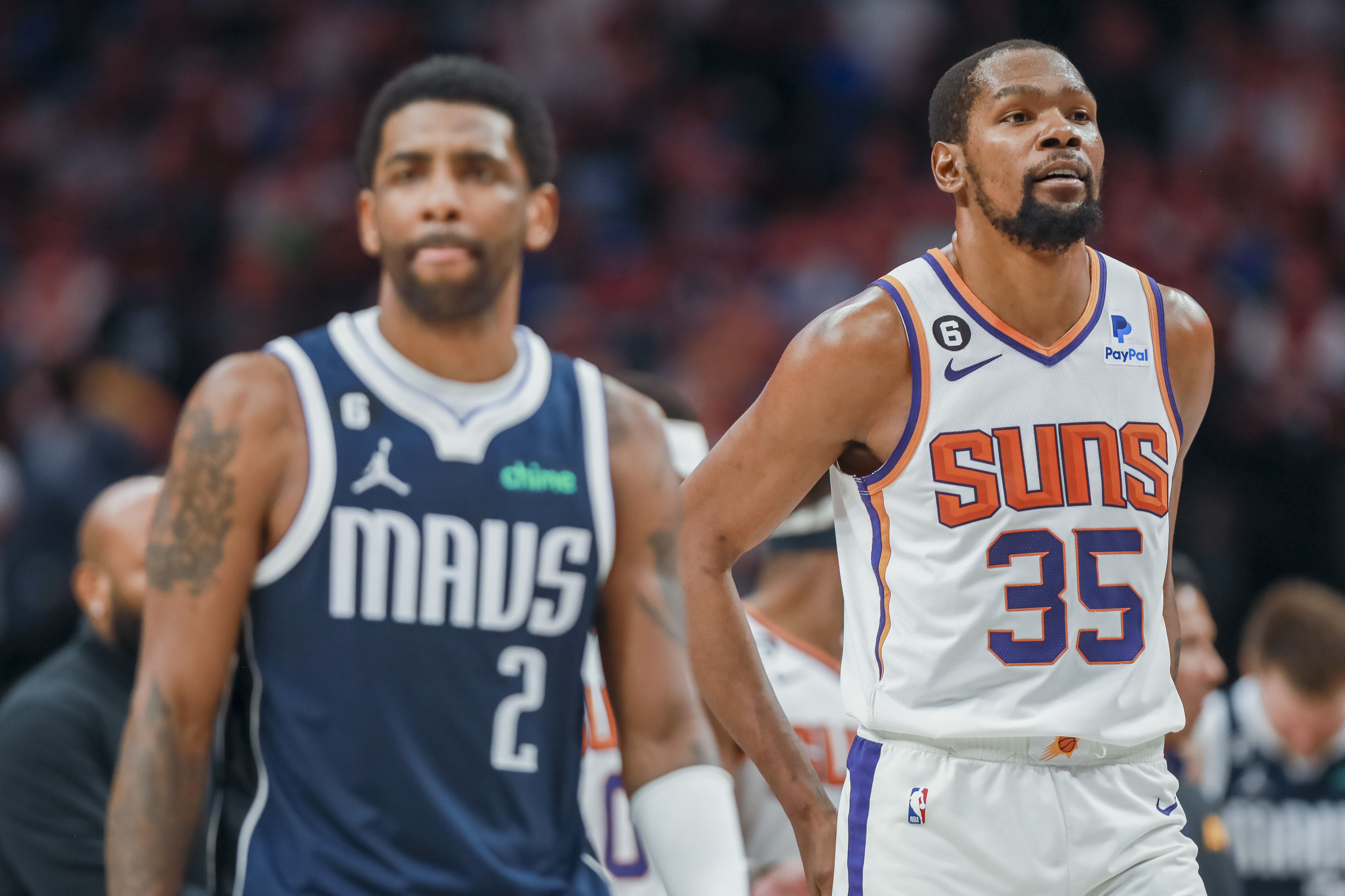 Dallas Mavericks guard Kyrie Irving (2) and Phoenix Suns forward Kevin Durant (35) walk down the court during the second half of an NBA basketball game, Sunday, March 5, 2023, in Dallas.