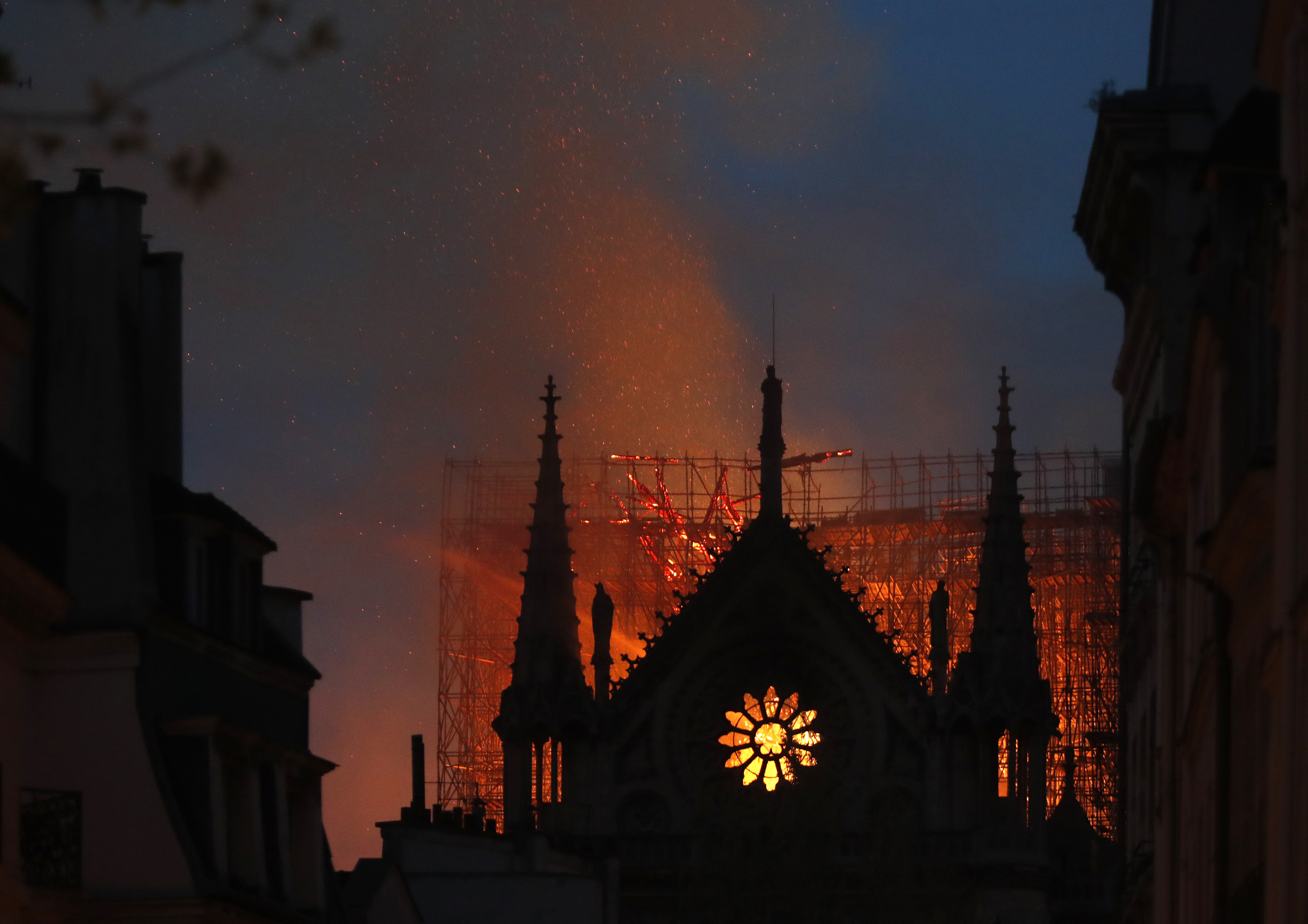 Flames and smoke rise from Notre Dame cathedral in Paris, April 15, 2019. France's Notre Dame Cathedral's reconstruction is progressing enough to allow its reopening to visitors and masses at the end of next year, less than six years after the shocking fire that tore through its roof, French officials said as an exhibit pays tribute to hundreds of artisans working on it.