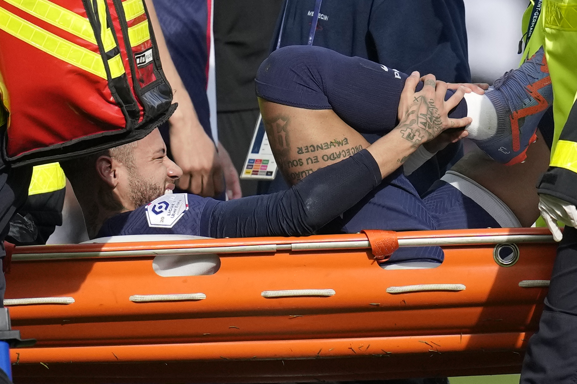 PSG's Neymar is carried off the field on a stretcher after after injuring during the French League One soccer match between Paris Saint-Germain and Lille at the Parc des Princes stadium, in Paris, France, Sunday, Feb. 19, 2023.