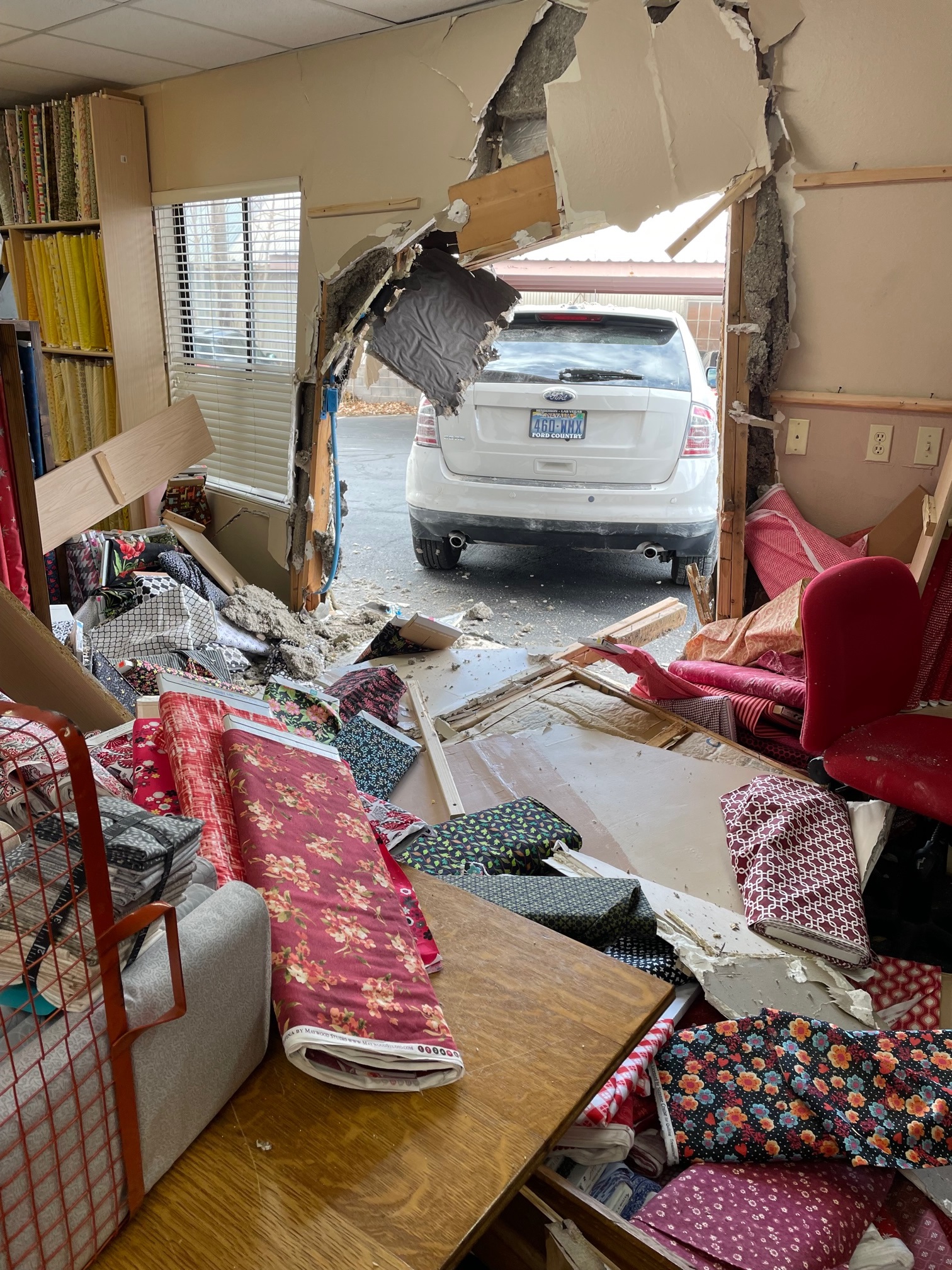 A woman's car crashed into a quilting store at 2721 W. Santa Clara Drive in Santa Clara, Washington County, on Monday after her shoe slipped off and became stuck against the gas pedal.
