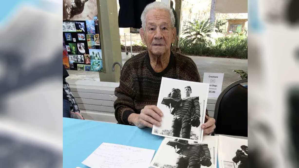 Ricou Browning, who played the creature in "Creature from the Black Lagoon," poses for photos for people during Florida SpringsFest at Silver Springs State Park in Silver Springs, Fla., March 4, 2018. Browning has died. He was 93.