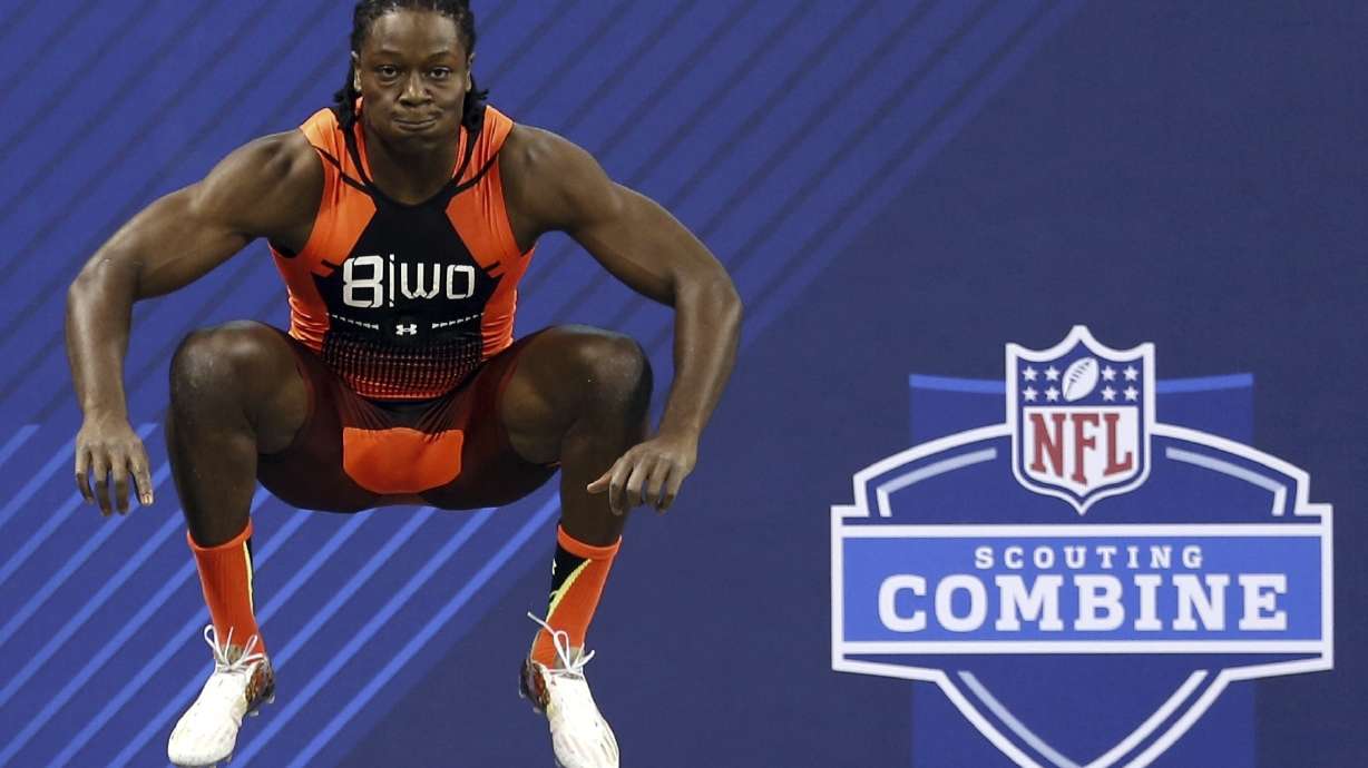FILE - Georgia wide receiver Chris Conley prepares to run the 40-yard dash at the NFL football scouting combine, Feb. 21, 2015, in Indianapolis. Conley jumped 45.0 inches in the vertical jump at the combine.