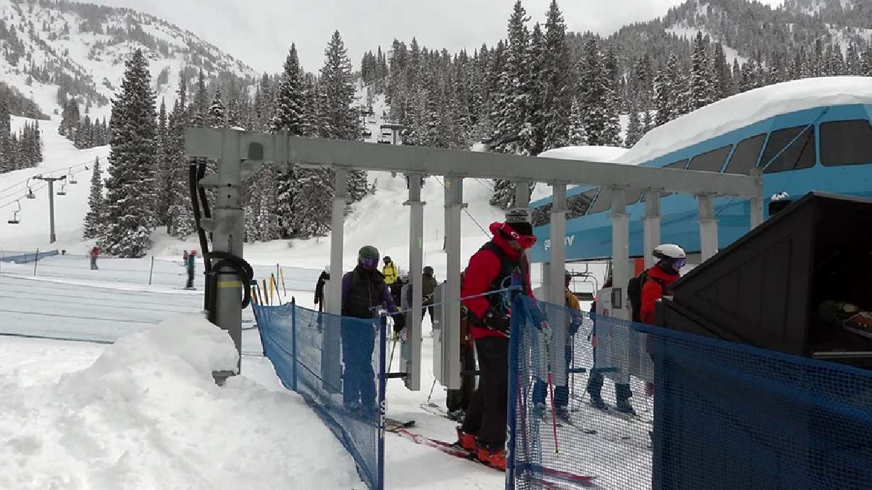 Skiers wait for transportation Monday in Little Cottonwood Canyon. As round after round of snow continues to hit Utah’s mountains, ski resort employees are working overtime to get the runs ready each day.