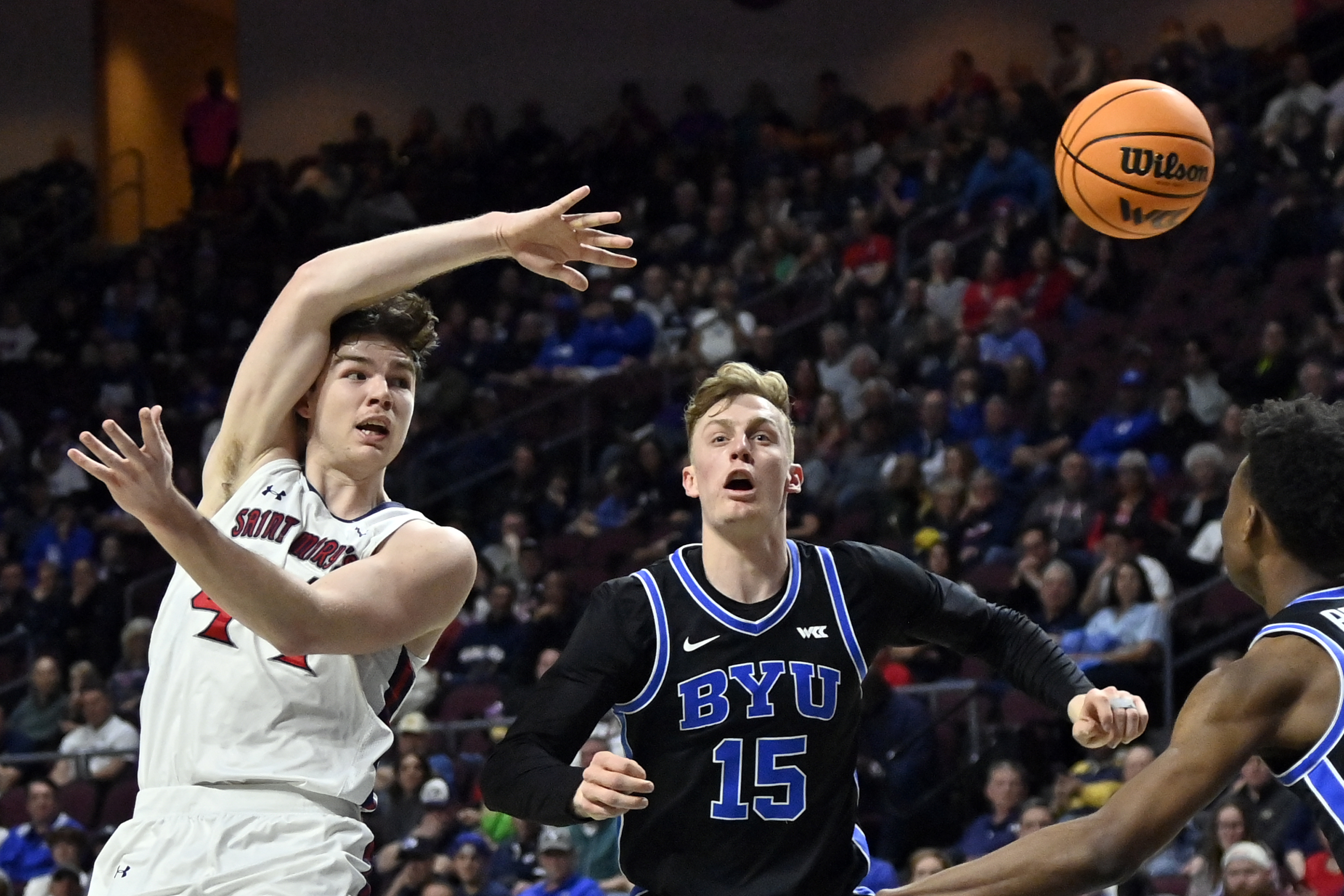 Saint Mary's guard Alex Ducas, left, passes the ball against BYU guard Richie Saunders (15) during the first half of an NCAA college basketball game in the semifinals of the West Coast Conference men's tournament Monday, March 6, 2023, in Las Vegas.