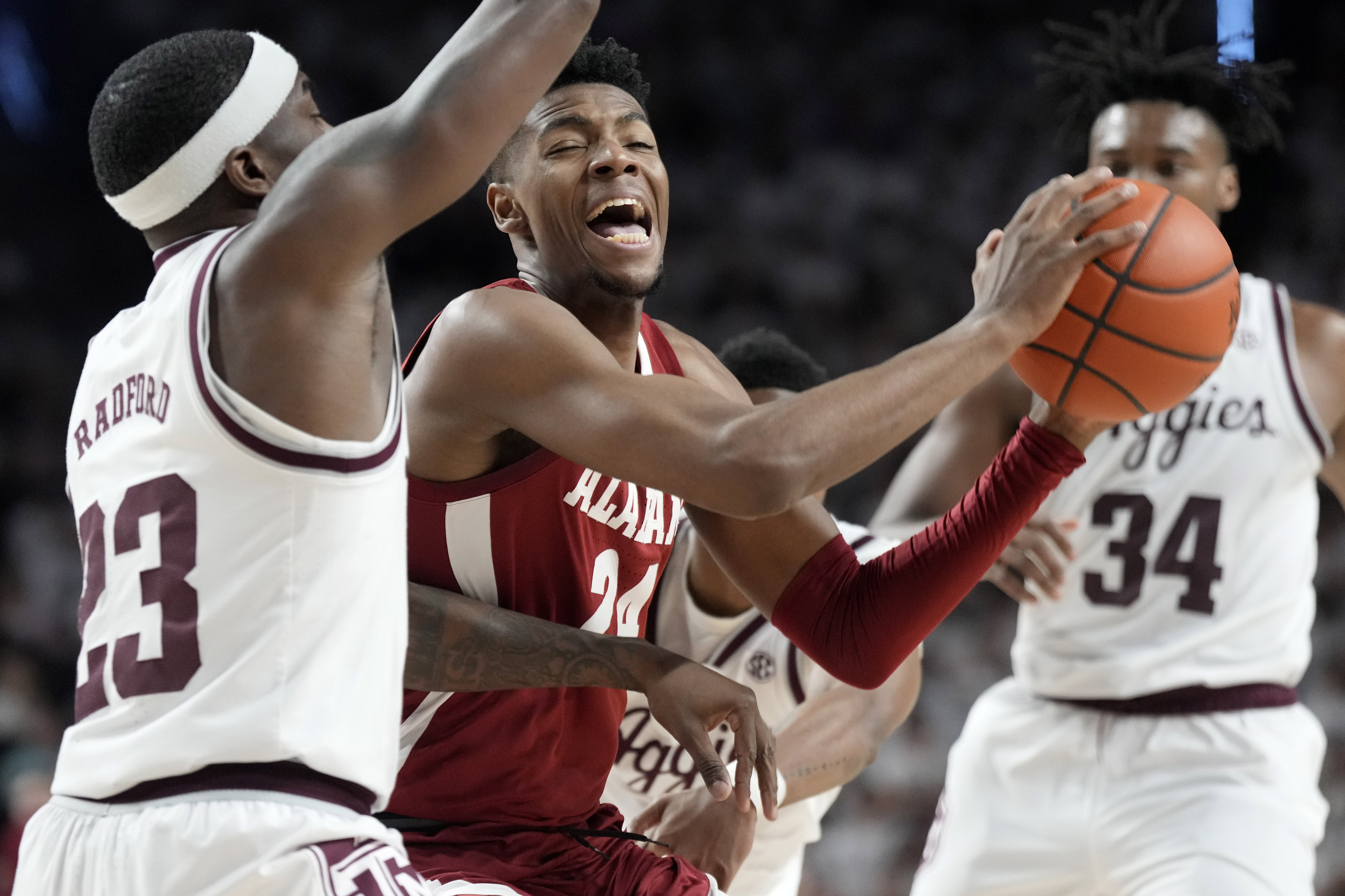 Alabama forward Brandon Miller (24) tries to drive the lane against Texas A&M guard Tyrece Radford (23) during the first half of an NCAA college basketball game Saturday, March 4, 2023, in College Station, Texas.