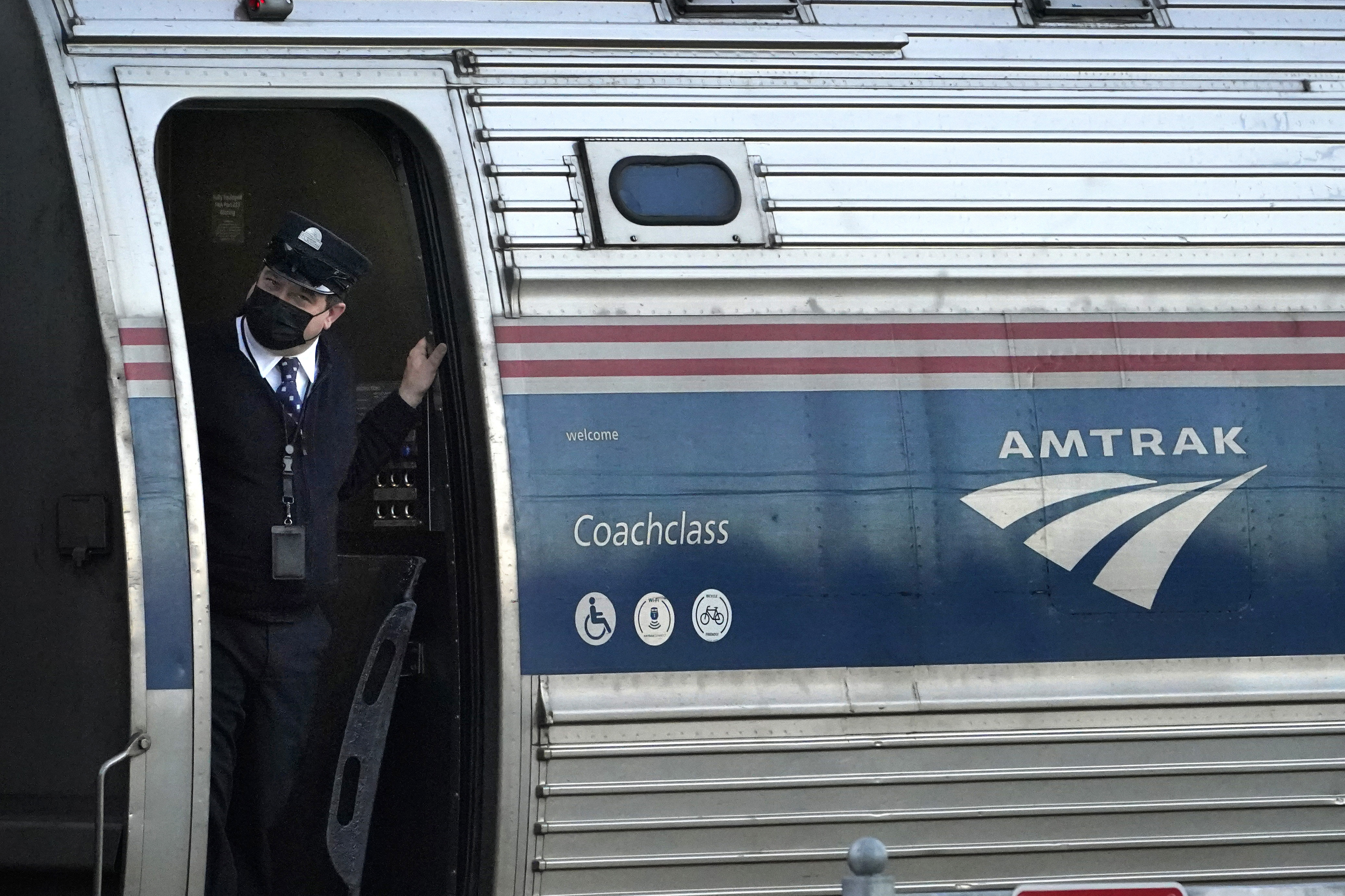 A conductor makes sure all is clear as the Amtrak Downeaster passenger train pulls out of the station in Freeport, Maine, on Dec. 14, 2021. Utah, Idaho and Nevada transportation officials are seeking funds to study a restoration of rail service from Boise to Las Vegas via Salt Lake City.