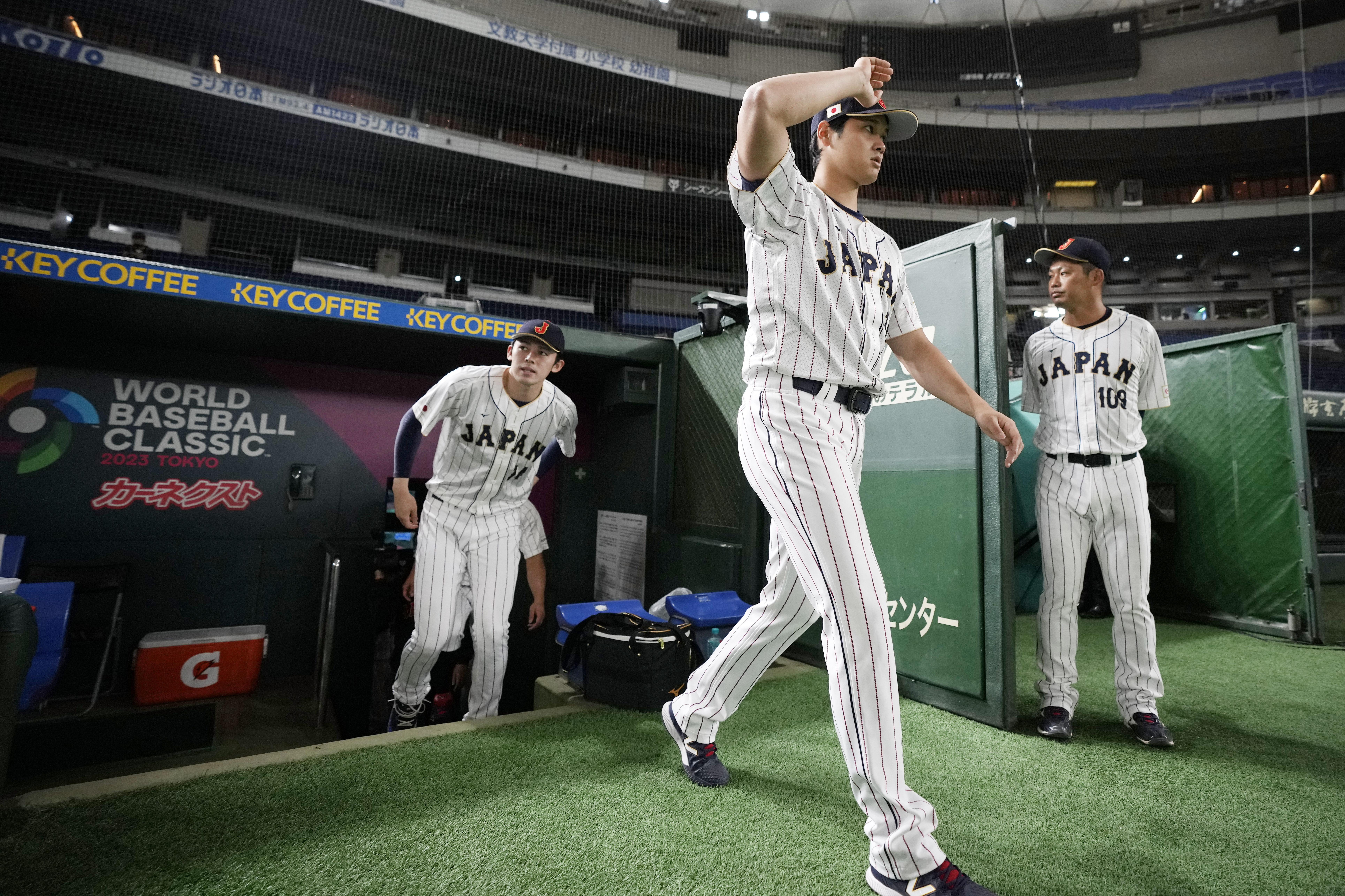 Japan's Shohei Ohtani, walks to participate a group photo session before an official training session prior to the Pool B game at the World Baseball Classic (WBC) at the Tokyo Dome Wednesday, March 8, 2023, in Tokyo. 
