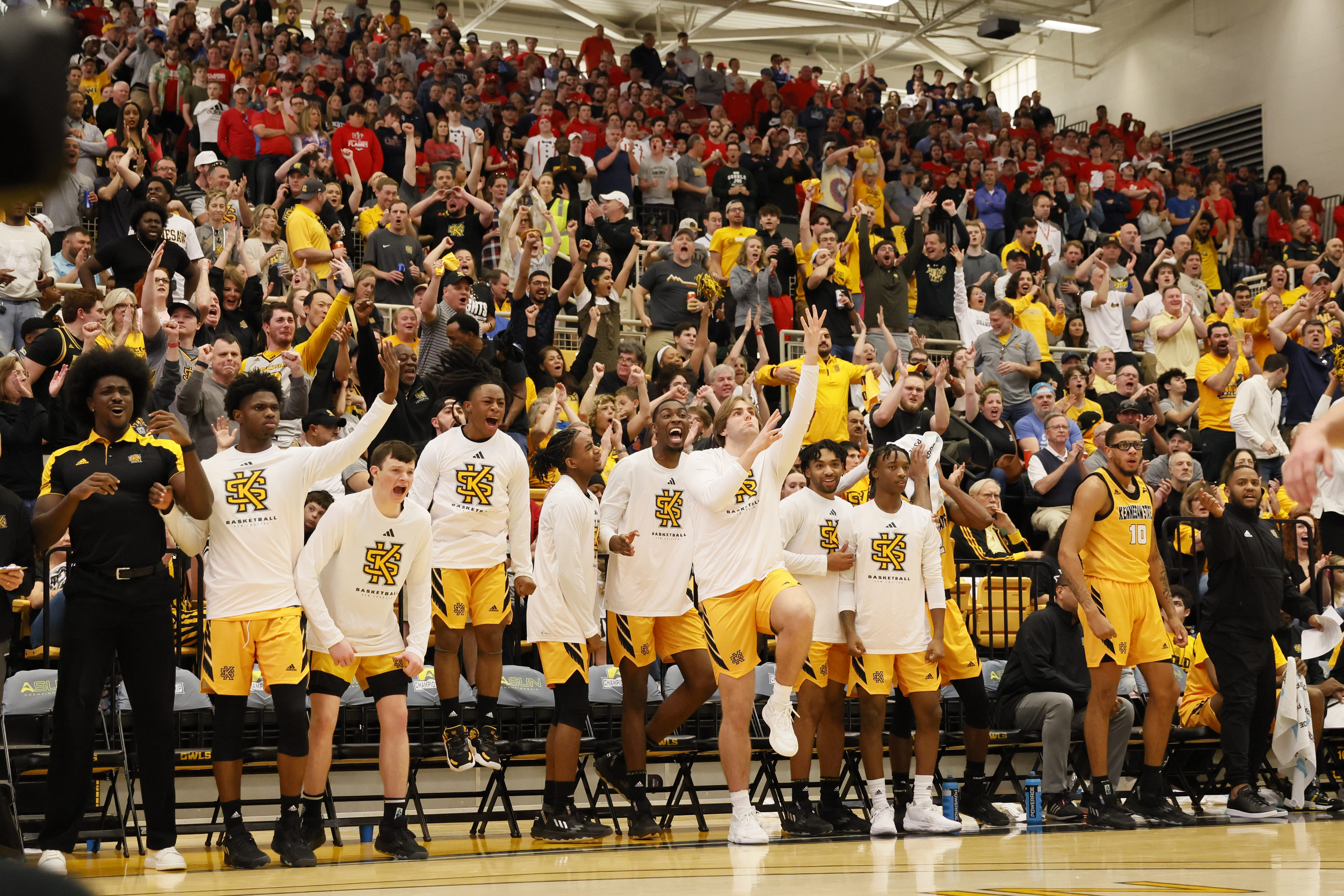 Kennesaw State's bench and fans react after a basket during the second half of the ASUN Conference championship basketball game against Liberty, Sunday, March 5, 2023, in Kennesaw, Ga. 