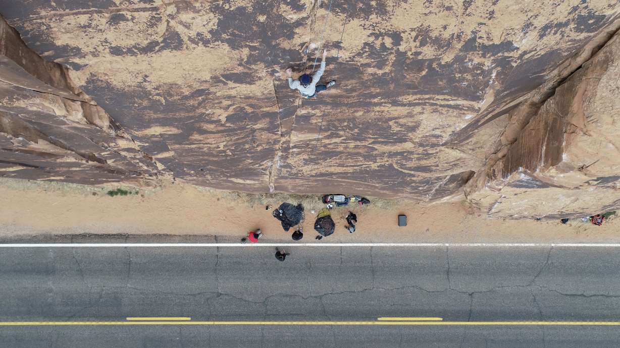 A rock climber scales a cliff in Moab in 2019. Utah Rep. John Curtis co-introduced a federal bill Tuesday aimed at preserving rock climbing access on federal land.