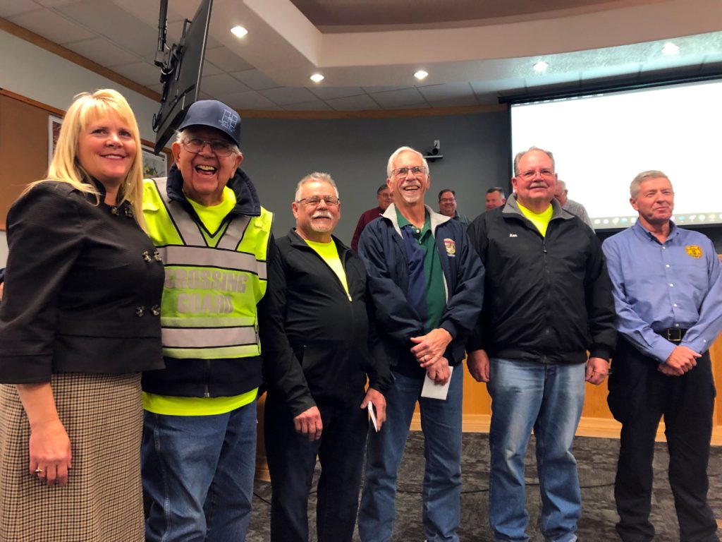 Hurricane Mayor Nanette Billings, crossing guards Dave Lusk, Dave Moody, Gary Marisk, Ken Twitchell and Police Chief Lynn Excell pose during a council meeting in Hurricane on Friday as the city honored the crossing guards.
