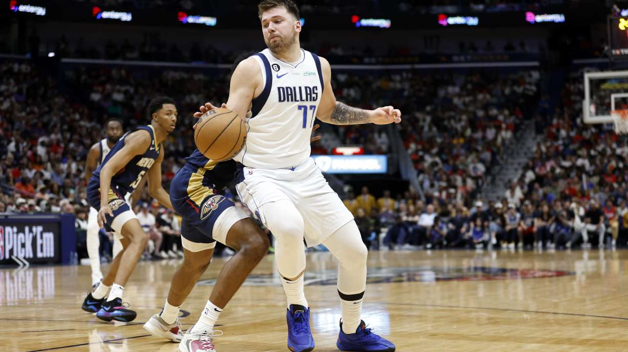 Dallas Mavericks guard Luka Doncic (77) drives past New Orleans Pelicans forward Herbert Jones (5) in the second half of an NBA basketball game in New Orleans, Wednesday, March 8, 2023. The Pelicans won 113-106.