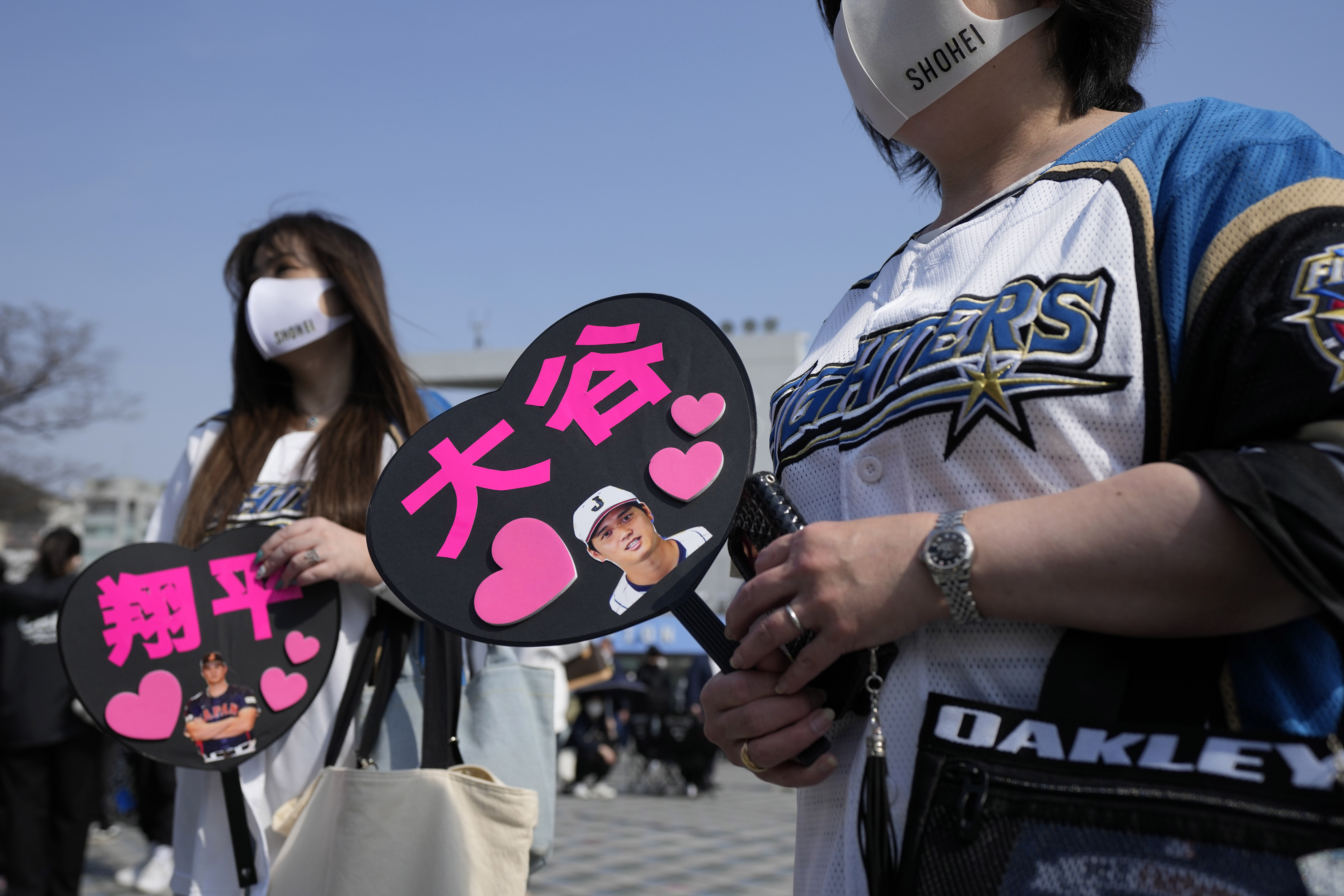 Fans of Japan's Shohei Ohtani cheer prior to the Pool B game between Japan and China at the World Baseball Classic (WBC) at the Tokyo Dome Thursday, March 9, 2023, in Tokyo. The paper fans read in Japanese "Ohtani, " right, and "Shohei." Japanese baseball player Shohei Ohtani is arguably the game's best player. But he's more than just a baseball player. He's an antidote for many in his native country. 