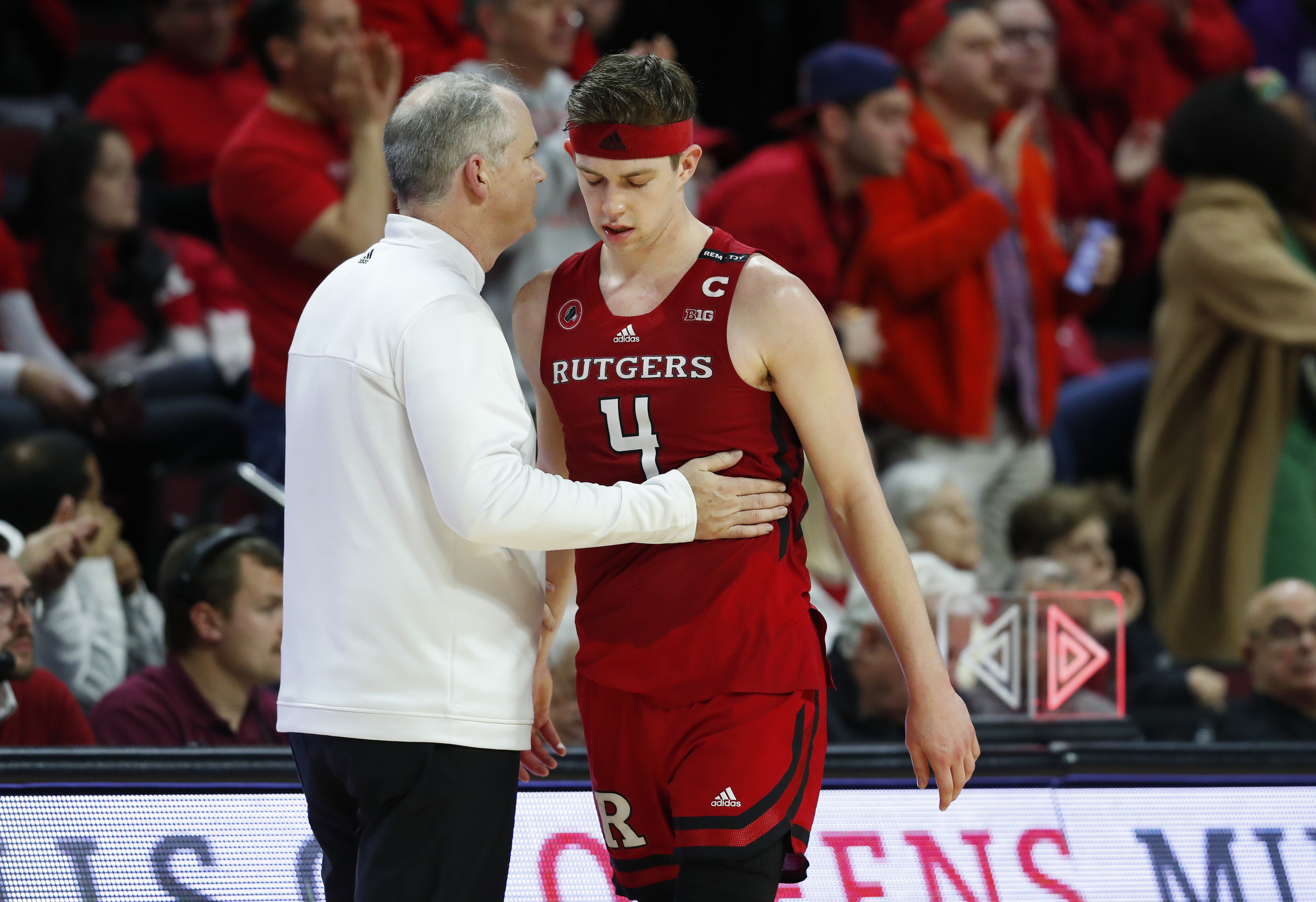 Rutgers head coach Steve Pikiell talks to guard Paul Mulcahy (4) before going to the bench during the second half of an NCAA college basketball game against Northwestern, Sunday, March 5, 2023, in Piscataway, N.J. Northwestern won 65-53.