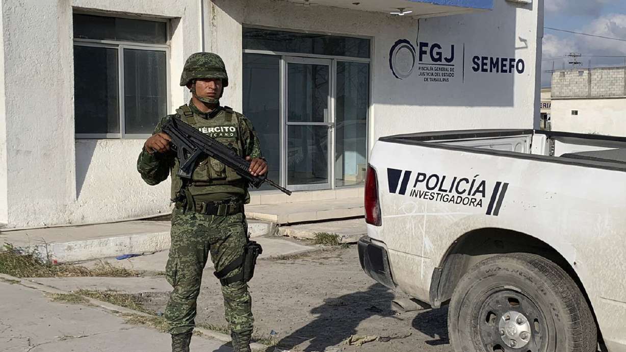 A Mexican army soldier guards the Tamaulipas State Prosecutor's headquarters in Matamoros, Mexico, Wednesday. A Mexican drug cartel allegedly responsible for the abduction of four Americans — two of whom died — has condemned the violence and purportedly turned over its own members who were involved to authorities.