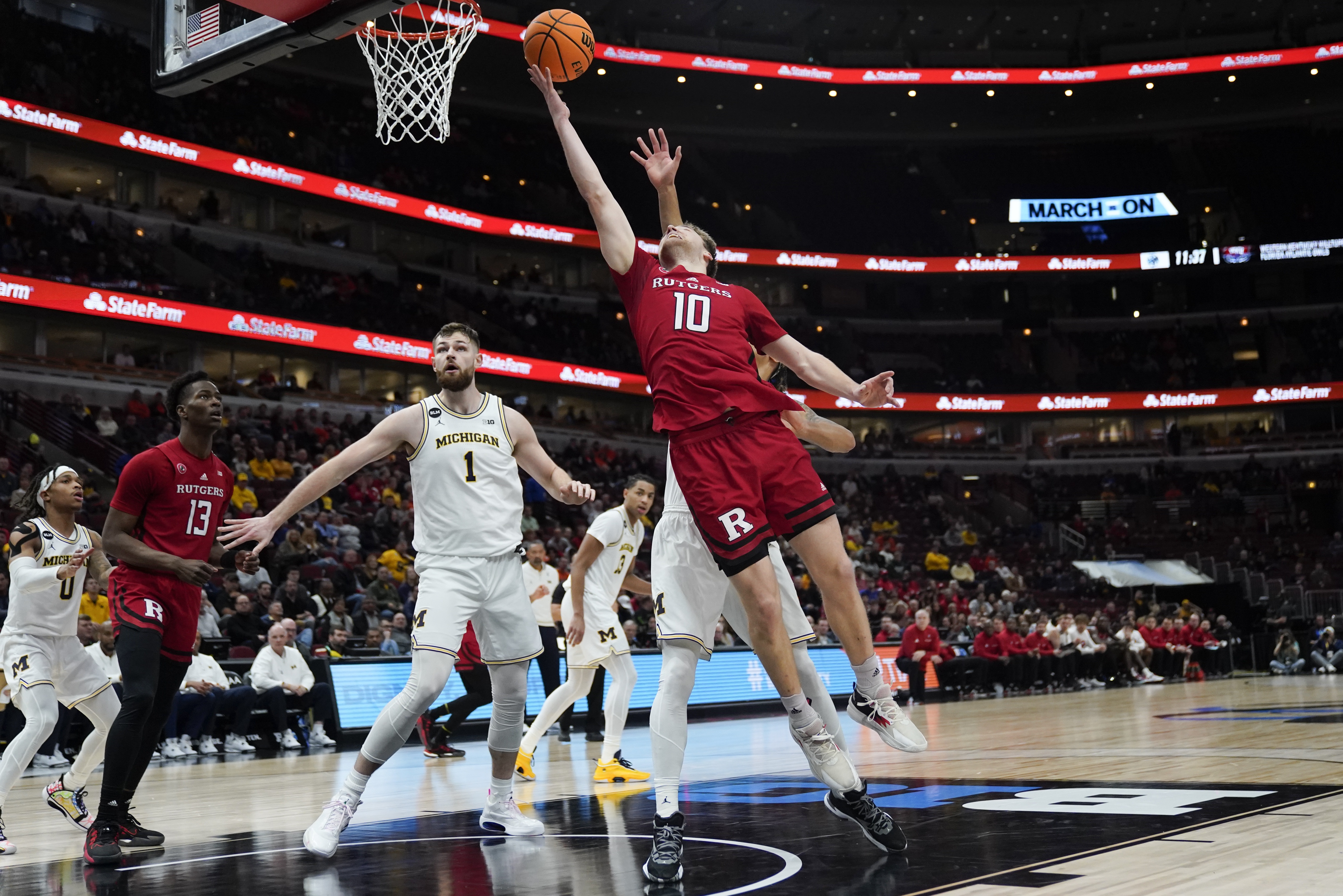 Rutgers' Cam Spencer (10) goes up for a basket during the first half of an NCAA college basketball game against Michigan at the Big Ten men's tournament, Thursday, March 9, 2023, in Chicago. 