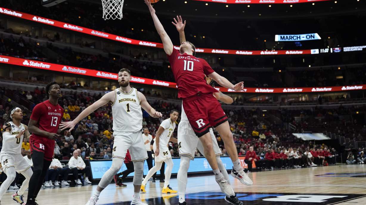 Rutgers' Cam Spencer (10) goes up for a basket during the first half of an NCAA college basketball game against Michigan at the Big Ten men's tournament, Thursday, March 9, 2023, in Chicago.
