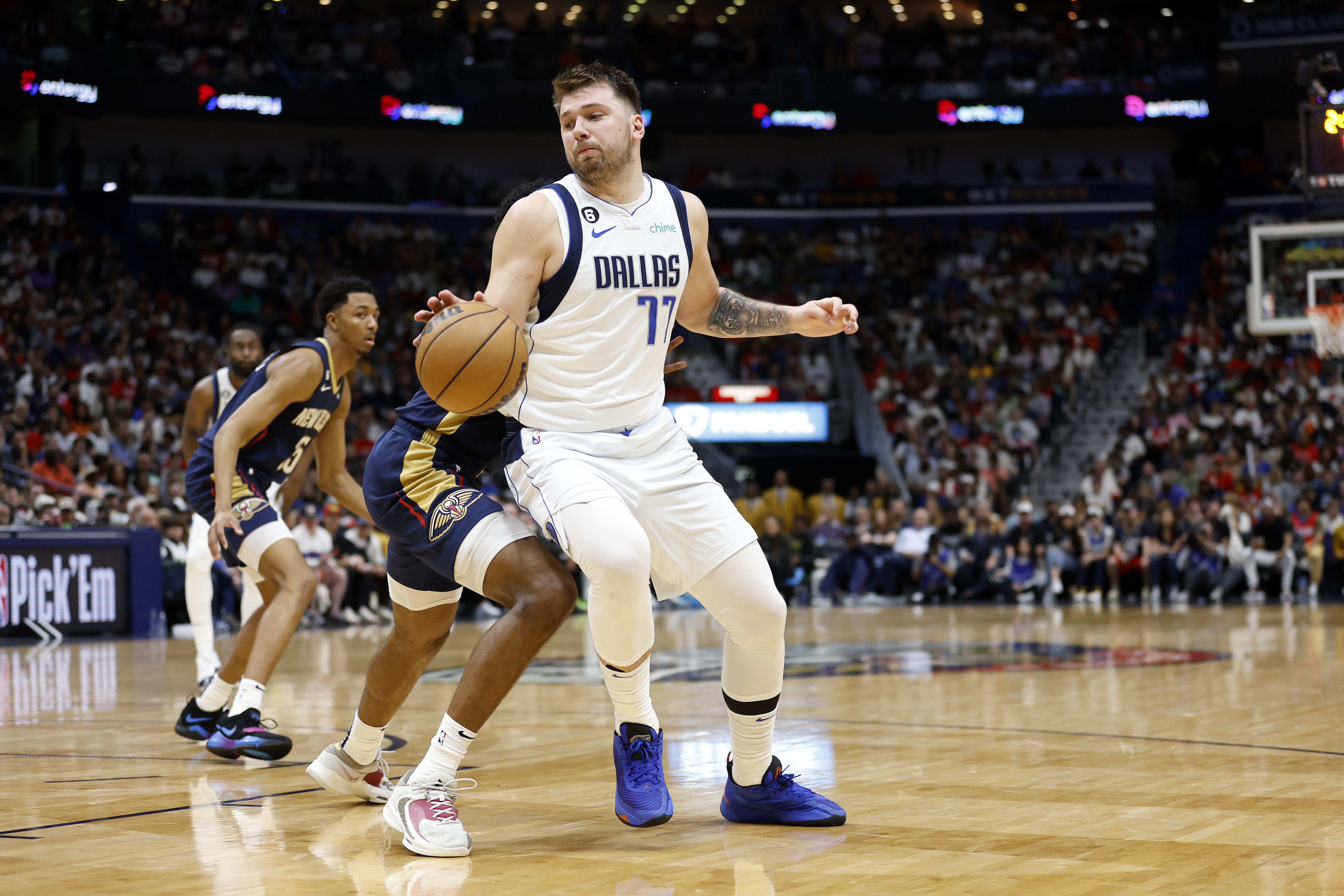 Dallas Mavericks guard Luka Doncic (77) drives past New Orleans Pelicans forward Herbert Jones (5) in the second half of an NBA basketball game in New Orleans, Wednesday, March 8, 2023. The Pelicans won 113-106. 