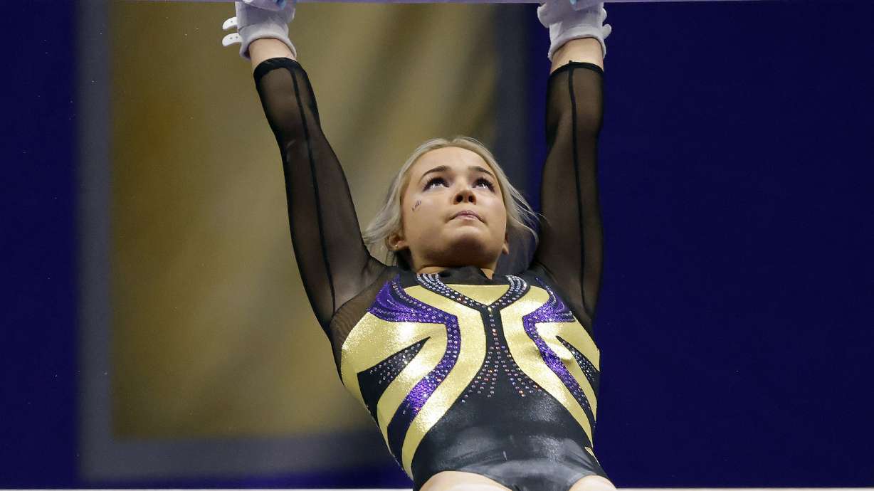 FILE -LSU gymnast Olivia Dunne competes during an NCAA gymnastics meet against Arkansas on Friday, Jan. 8, 2021 in Baton Rouge, La. LSU gymnast Olivia Dunne's endorsement of an artificial intelligence essay-writing product is raising questions about whether college athletic programs should provide clearer ethical guidelines for
