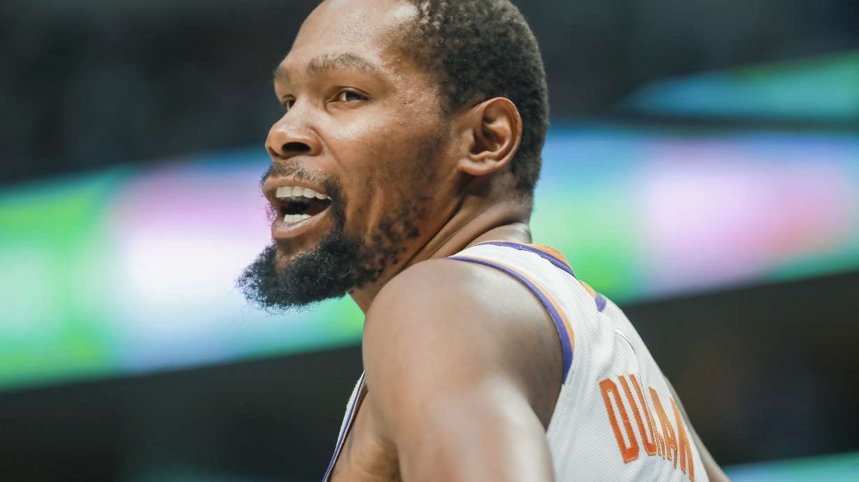 Phoenix Suns forward Kevin Durant interacts with a fan during the first half of an NBA basketball game against the Dallas Mavericks, Sunday, March 5, 2023, in Dallas.