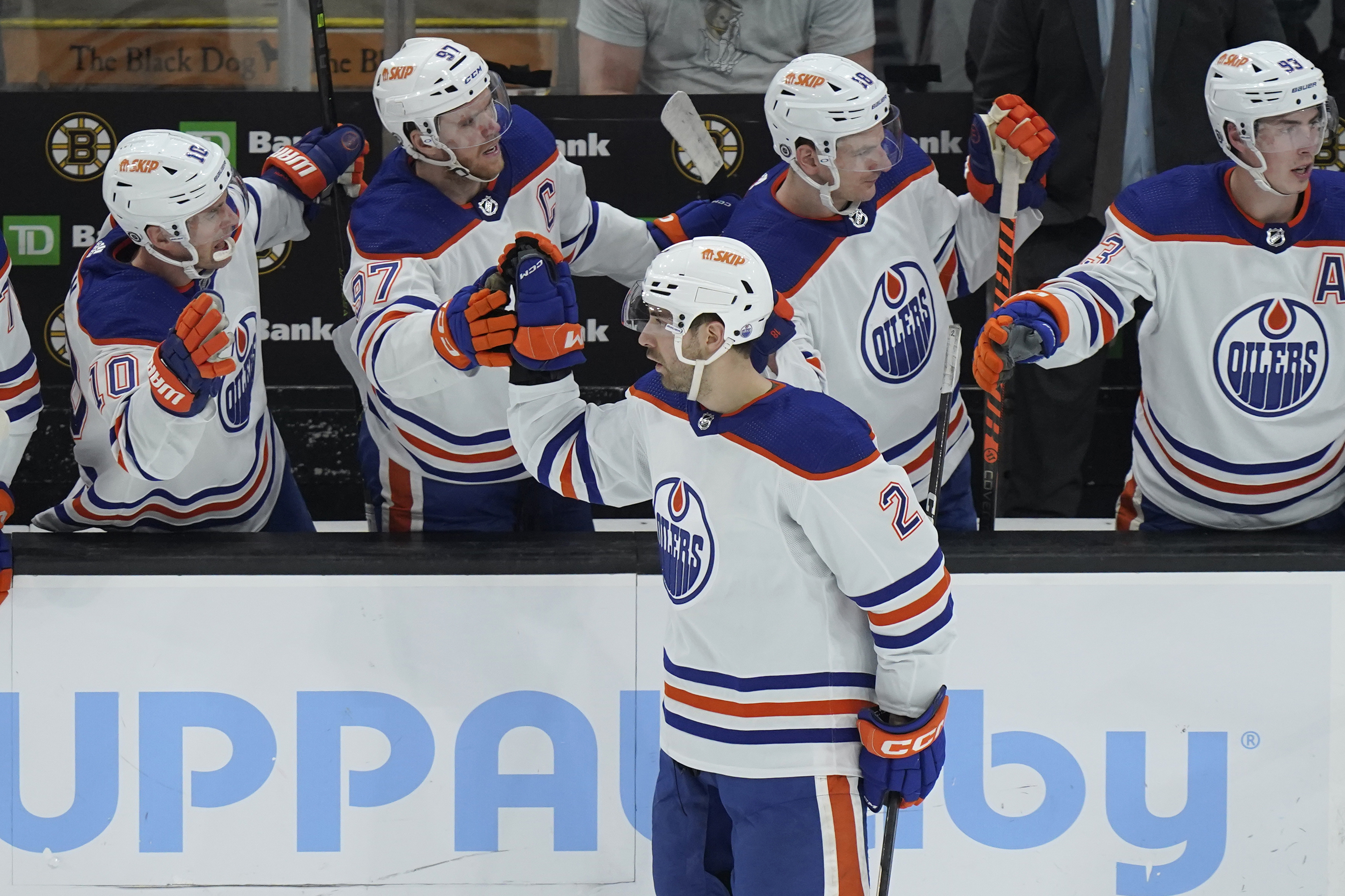 Edmonton Oilers defenseman Evan Bouchard (2) celebrates with teammates after scoring against the Boston Bruins during the second period of an NHL hockey game Thursday, March 9, 2023, in Boston. 
