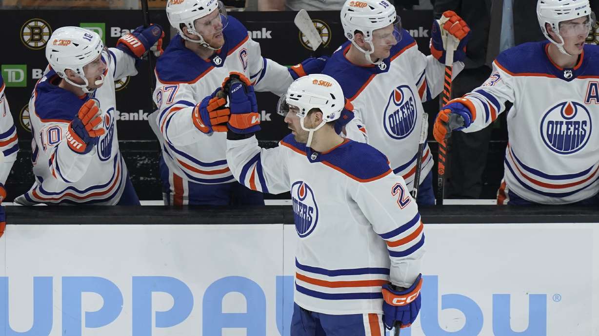 Edmonton Oilers defenseman Evan Bouchard (2) celebrates with teammates after scoring against the Boston Bruins during the second period of an NHL hockey game Thursday, March 9, 2023, in Boston.