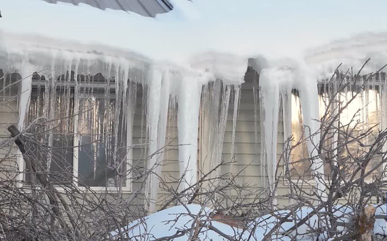Ice extends off the roof of a home near Park City. Typically ice dams that lead to interior water damage and damage from the weight of snow are covered by homeowners' insurance.