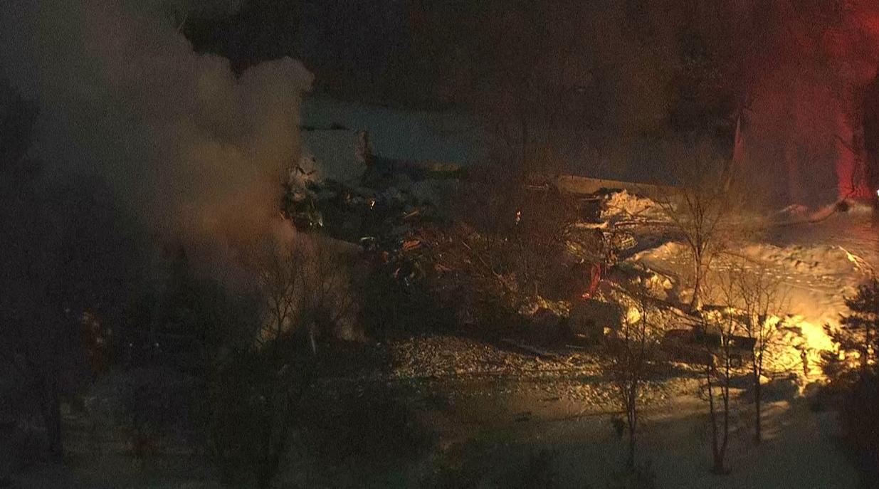 Firefighters work to extinguish a house fire in Cache County following an explosion March 9. Investigators determined the explosion was caused by a gas leak.